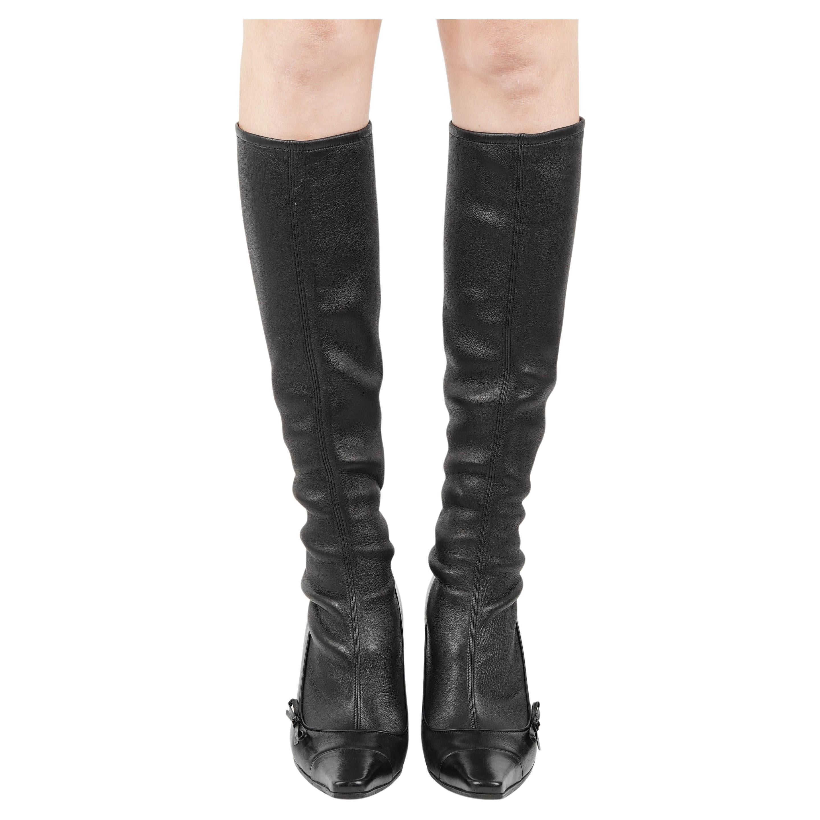 These chic Chanel black leather sock boots exude understated Parisian elegance, blending sleek minimalism with subtle house detailing. Crafted in Italy from supple black leather, the boots feature a fitted shaft that elongates the leg and a sharply