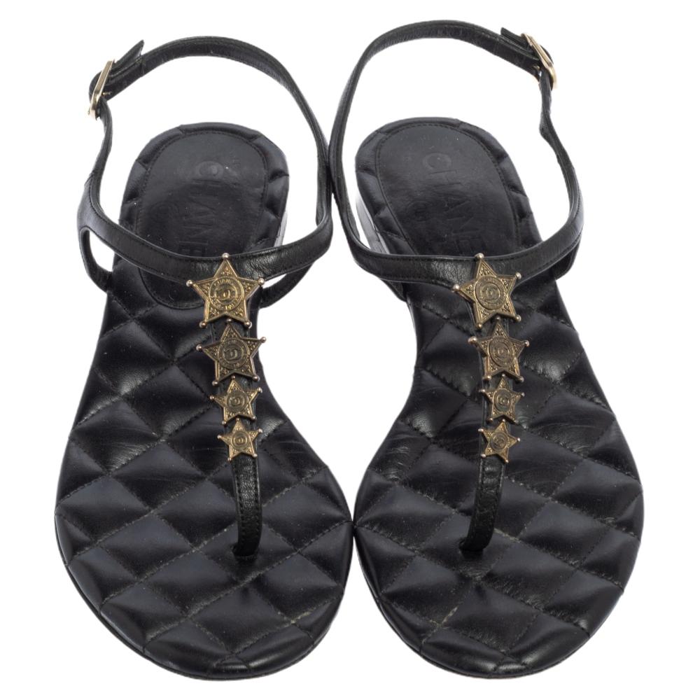 How pretty are these black flat sandals from the house of Chanel! They are designed with leather straps in a thong design with buckle fastenings and star embellishments. Team them with your casual dresses.

