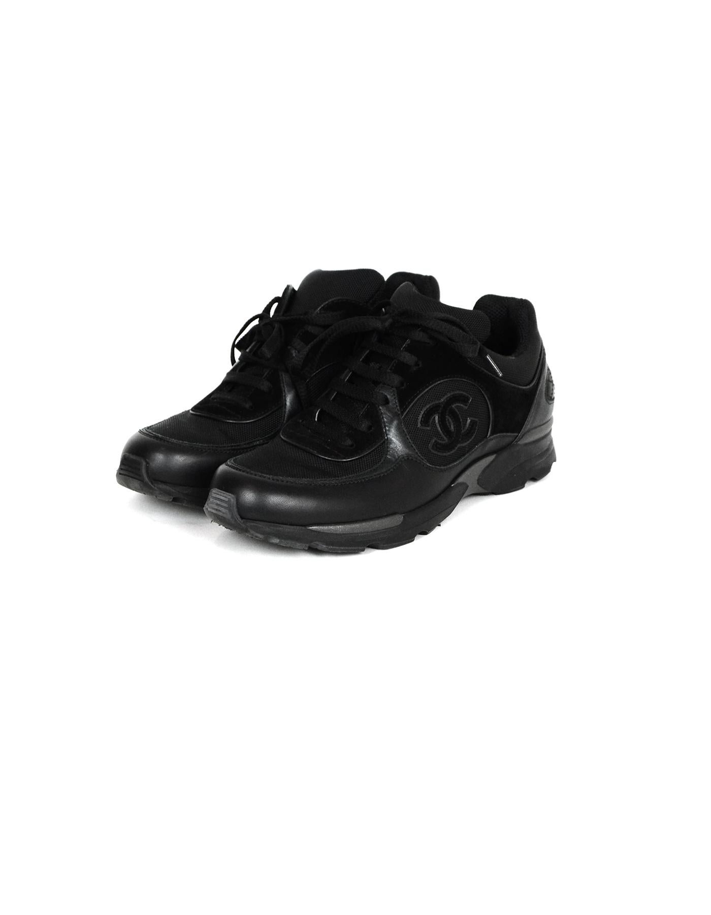 Chanel Black Leather/Suede Sneakers with CC Logo

Made In: Italy
Color: Black
Materials: Leather, suede
Closure/Opening: Lace-up 
Overall Condition: Excellent pre-owned condition, minor wear to soles
Estimated Retail: $850 + tax
Includes: