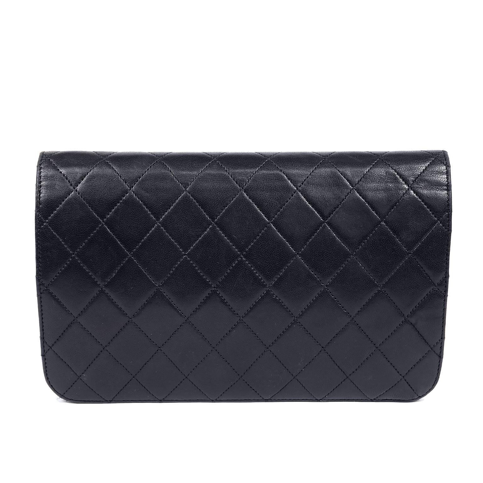 Chanel Black Leather Large Vintage Clutch with Strap- MINT Condition
Black leather large clutch is quilted in signature Chanel diamond pattern.  Gold interlocking CC conceals a snap closure.  Bordeaux leather interior has one side zippered pocket. 