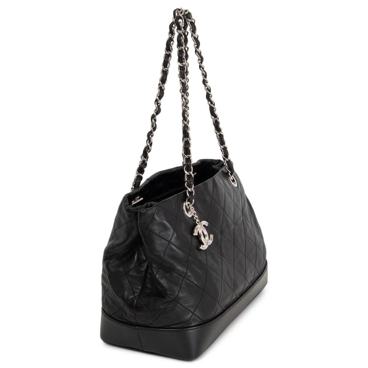 100% authentic  Chanel VIP Medium Shopping Bag in black iridescent smooth quilted calfskin with a hard bottom. Embellished with CC silver-tone metal charm and classic chain-link shoulder-straps. Opens with a zipper on top and is lined in beige