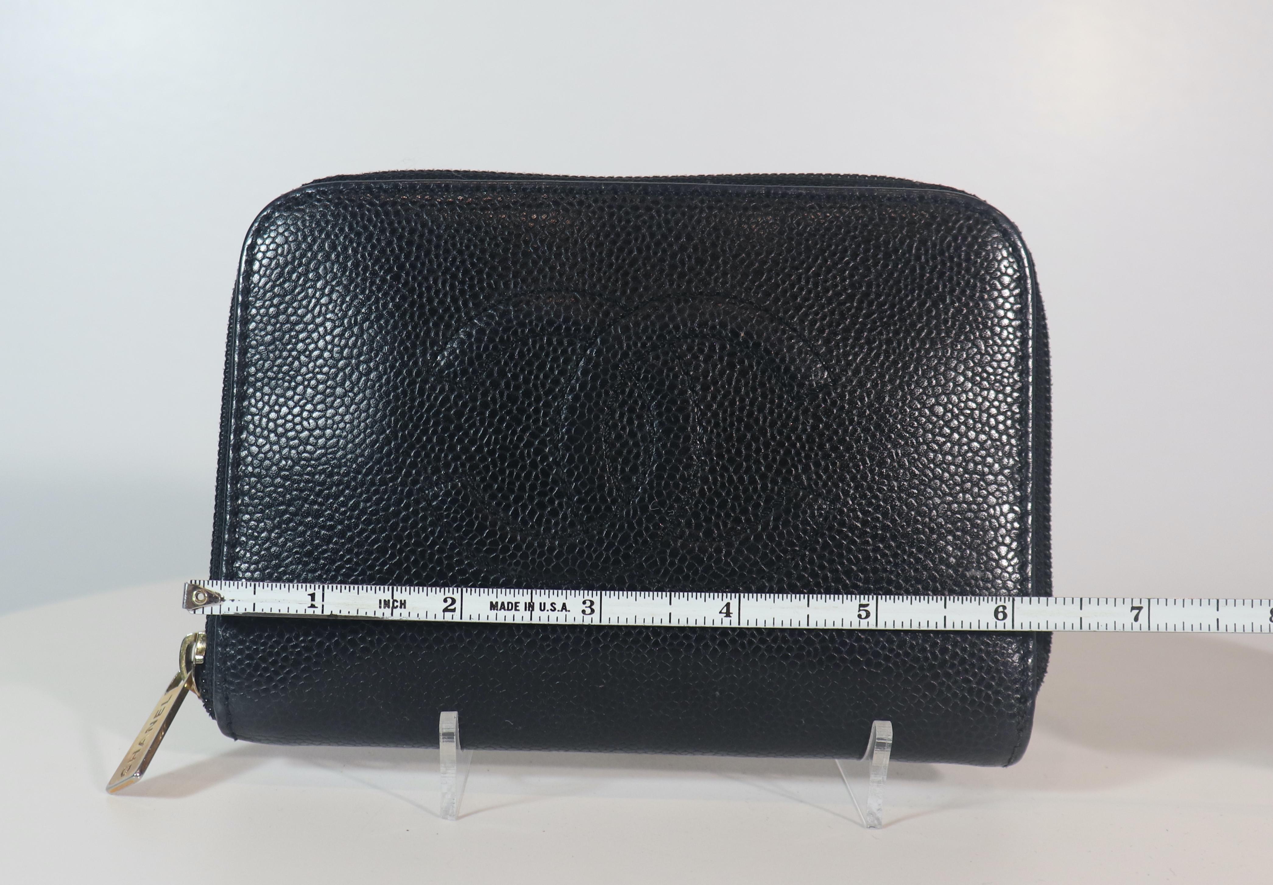 Chanel black leather wallet with stitched logo. This wallet is in 'LIKE NEW' condition. There are no significant flaws or wear areas to consider with this lovely wallet. It had been very gently used and carefully stored in its sleeper bag over the