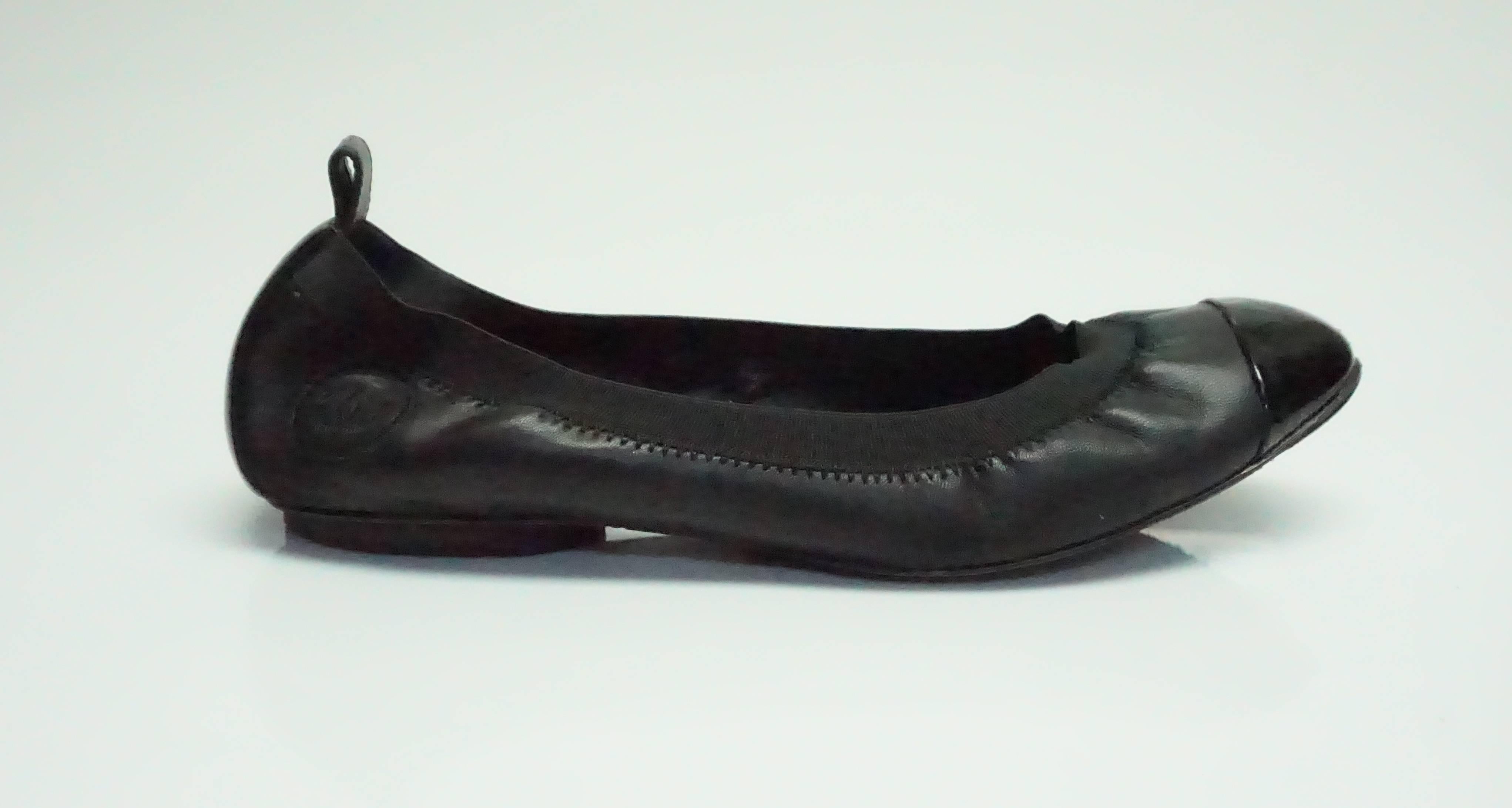 Chanel Black Leather/Rubber Elastic Cap-Toe Ballet Flats - 36.5  These flats are in good condition. There is a bit of wear to them in the inside of the shoe. The bottom of the shoe also has a bit of wear to them. The toe part of the shoe also has