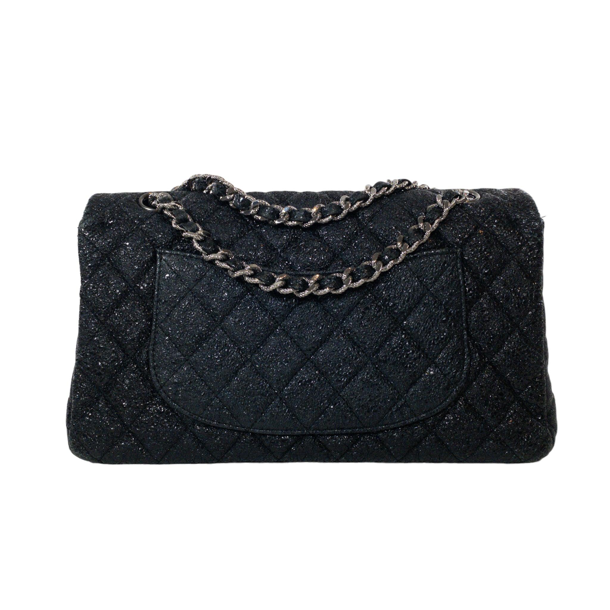 Chanel Black Limited Edition Medium Classic Flap SHW Bag

This is an authentic Chanel Medium Classic Flap. The bag has a flap closure with a Double C logo turn lock. Limited edition piece from A/W 2007 collection in textured metallic black leather
