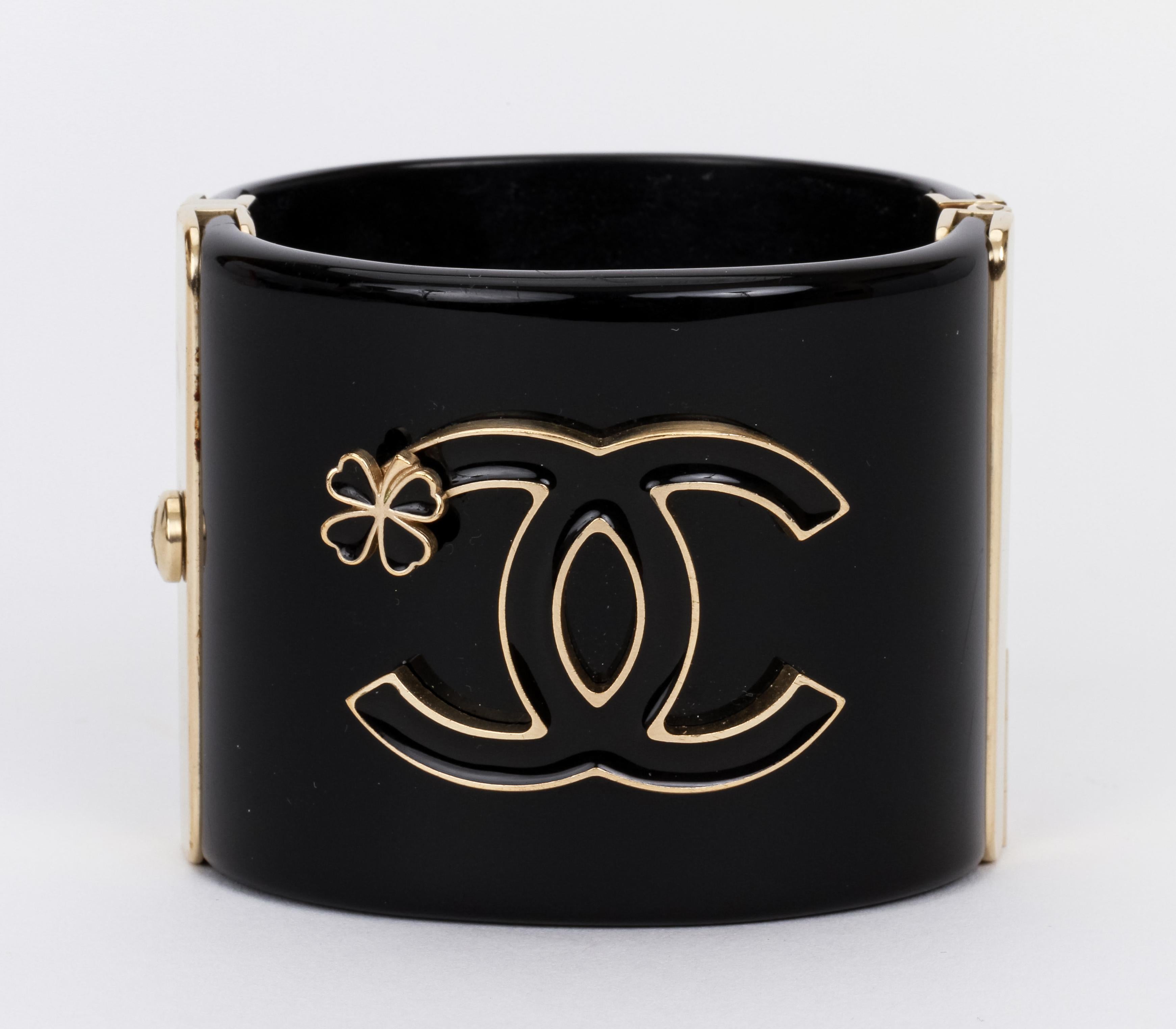 Important Chanel black lucite hinged oval cuff, CC logo with clover. Comes with original box.
