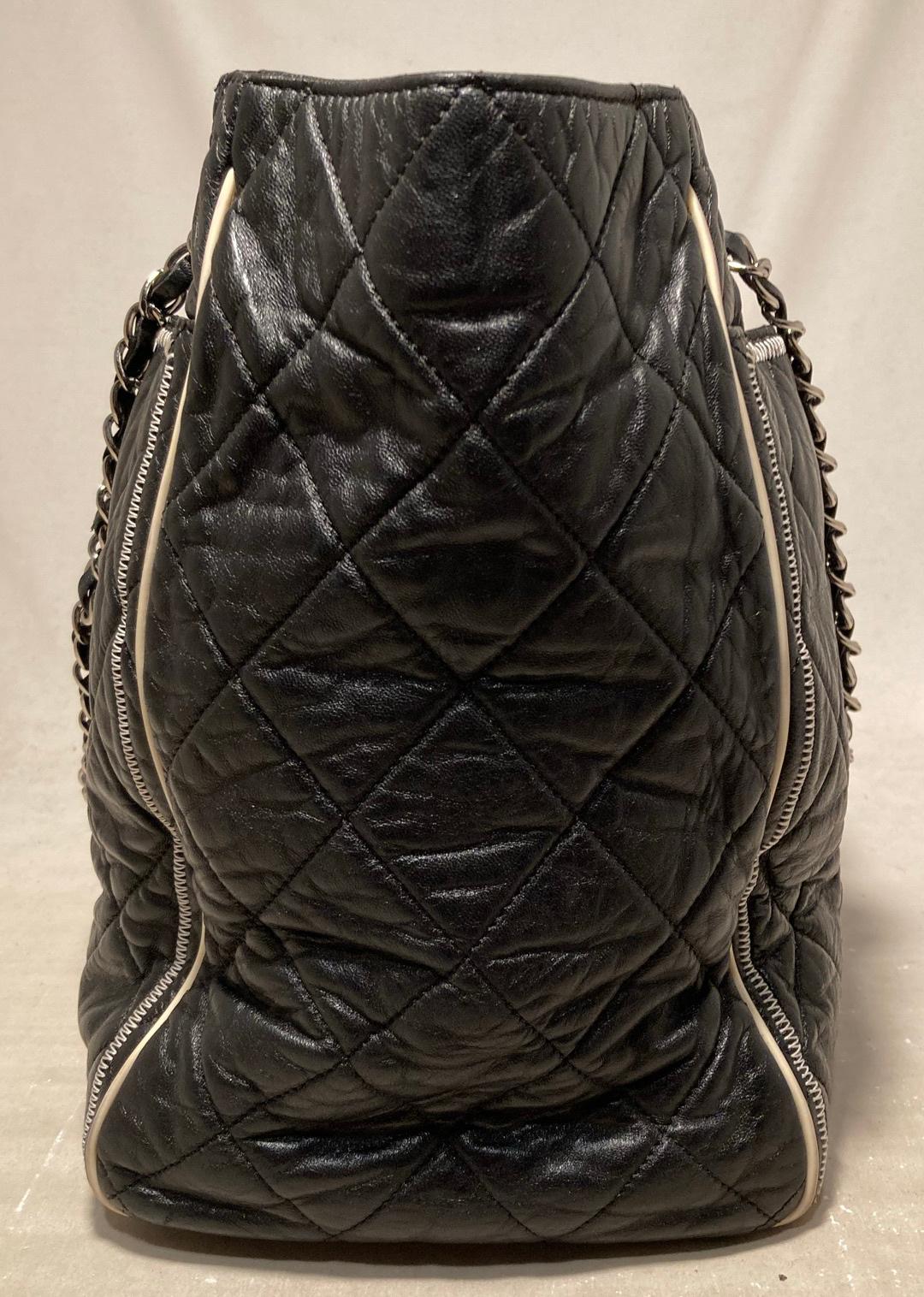 Chanel Black Leather Mademoiselle Lock Front East West Tote in excellent condition. Quilted black lambskin leather exterior trimmed with cream leather piping and silver hardware. Woven leather and chain double shoulder straps can be worn short or