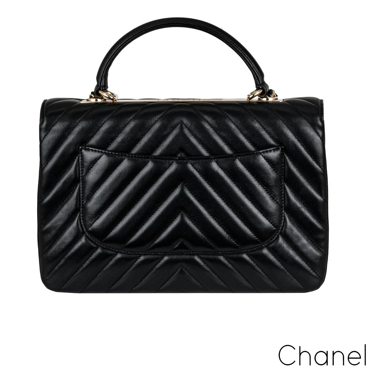 A stylish black Chanel Medium Trendy CC Flap Bag. The exterior of this Trendy is crafted with black lambskin leather in the signature chevron style stitching and gold-tone hardware. It features a front flap with signature CC turnlock closure, half