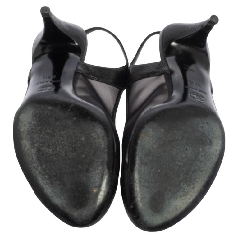 Chanel yet again brings a stunning set of sandals that makes us marvel at its beauty and craftsmanship. Crafted from mesh and exotic lizard in a black shade, they are secured with slingbacks and raised on sturdy heels. To finish off, the cap toes