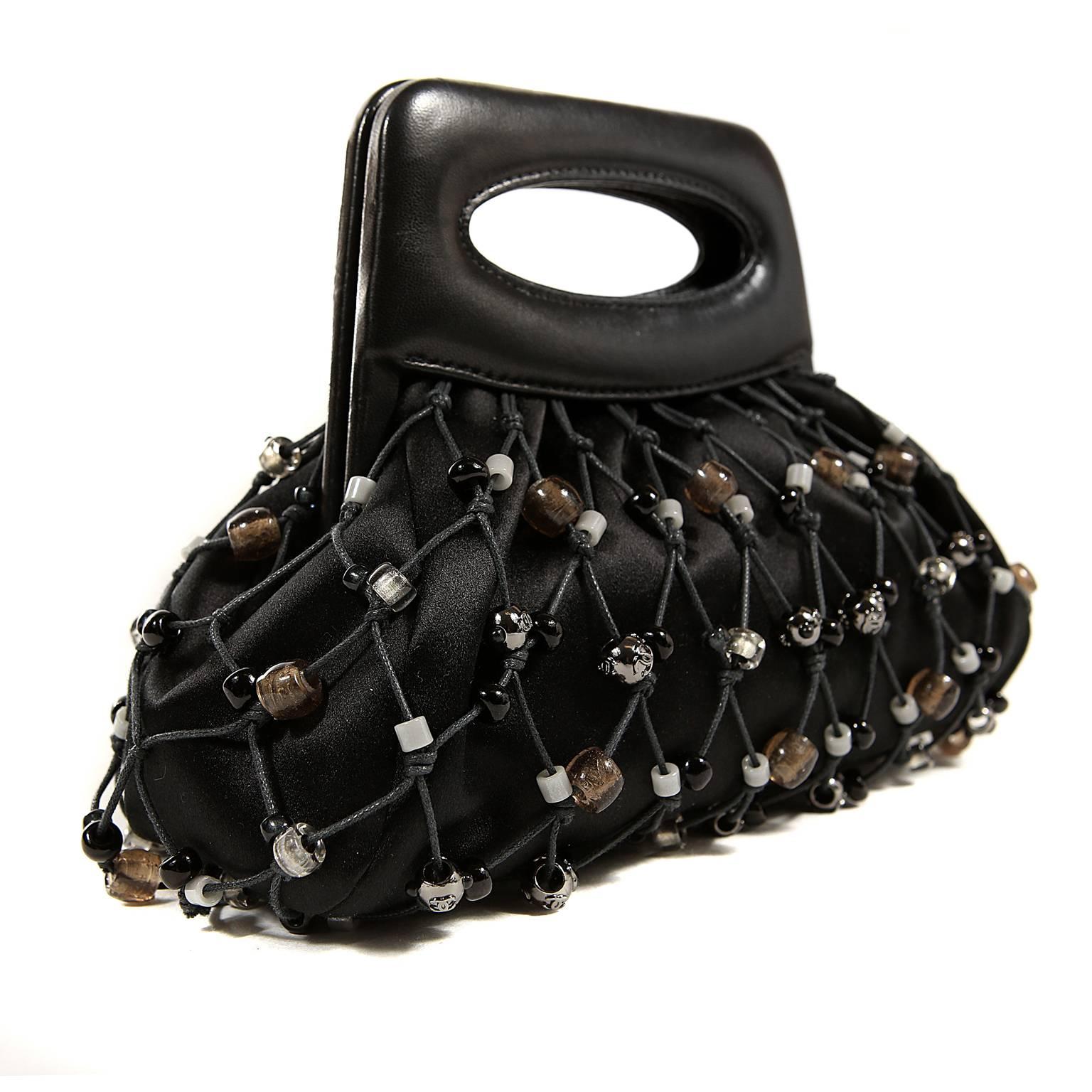 Chanel Black Satin Beaded Mesh Evening Bag- PRISTINE
 Elegant and unique, the neutral beading and mesh applique give this Chanel artistic flair. 
Black satin bag is surrounded by mesh netting that is further enhanced with neutral colored beads. 
