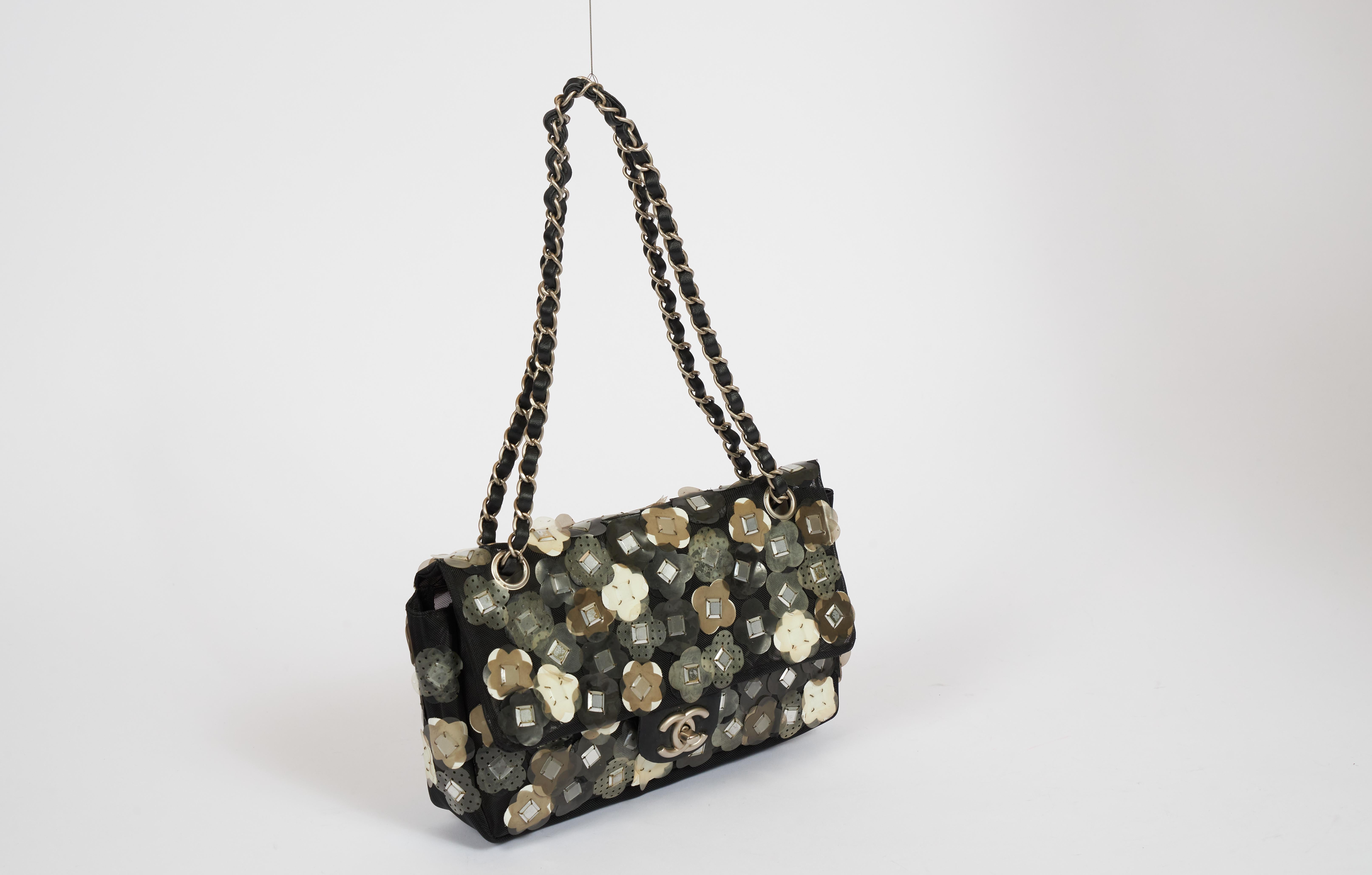 Chanel black mesh material evening bag with pvc applique' flowers. Comes with hologram and original dust cover. Shoulder drop 9