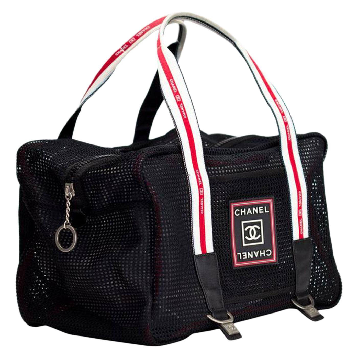 Medium sized Chanel black mesh sport bag with expandable snap detail

2006 {VINTAGE 18 Years}
Silver hardware
Lambskin leather detail
Rubber Chanel stamped logo
Zipper closure
Interior red sport trim
Large interior center pocket
Strap drop: 8”
8” H