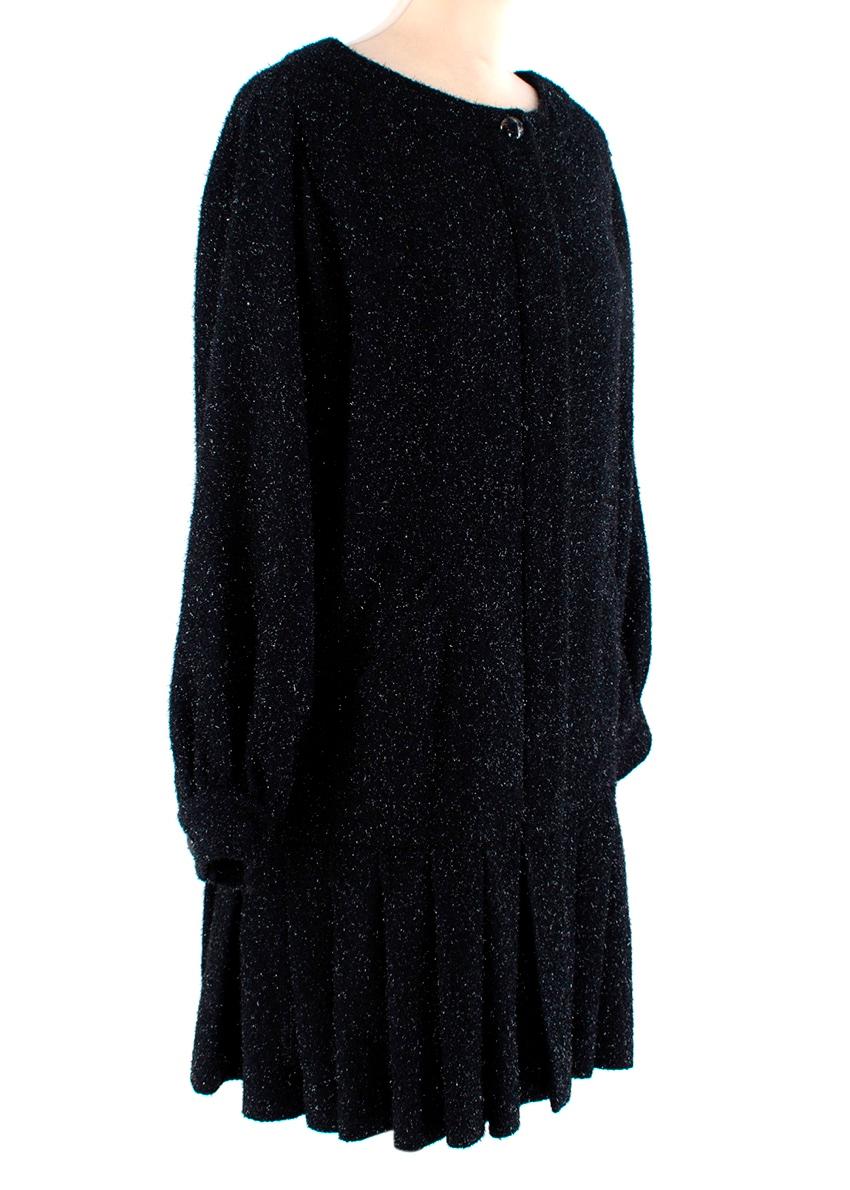 Chanel Black Metallic Boucle Dress Coat
 

 - Black boucle dress coat with a subtle glitter thread running through, and a deep navy undertone courtesy of a blue thread also within the weave
 - Drop waist pleated hemline giving the effect of a short,