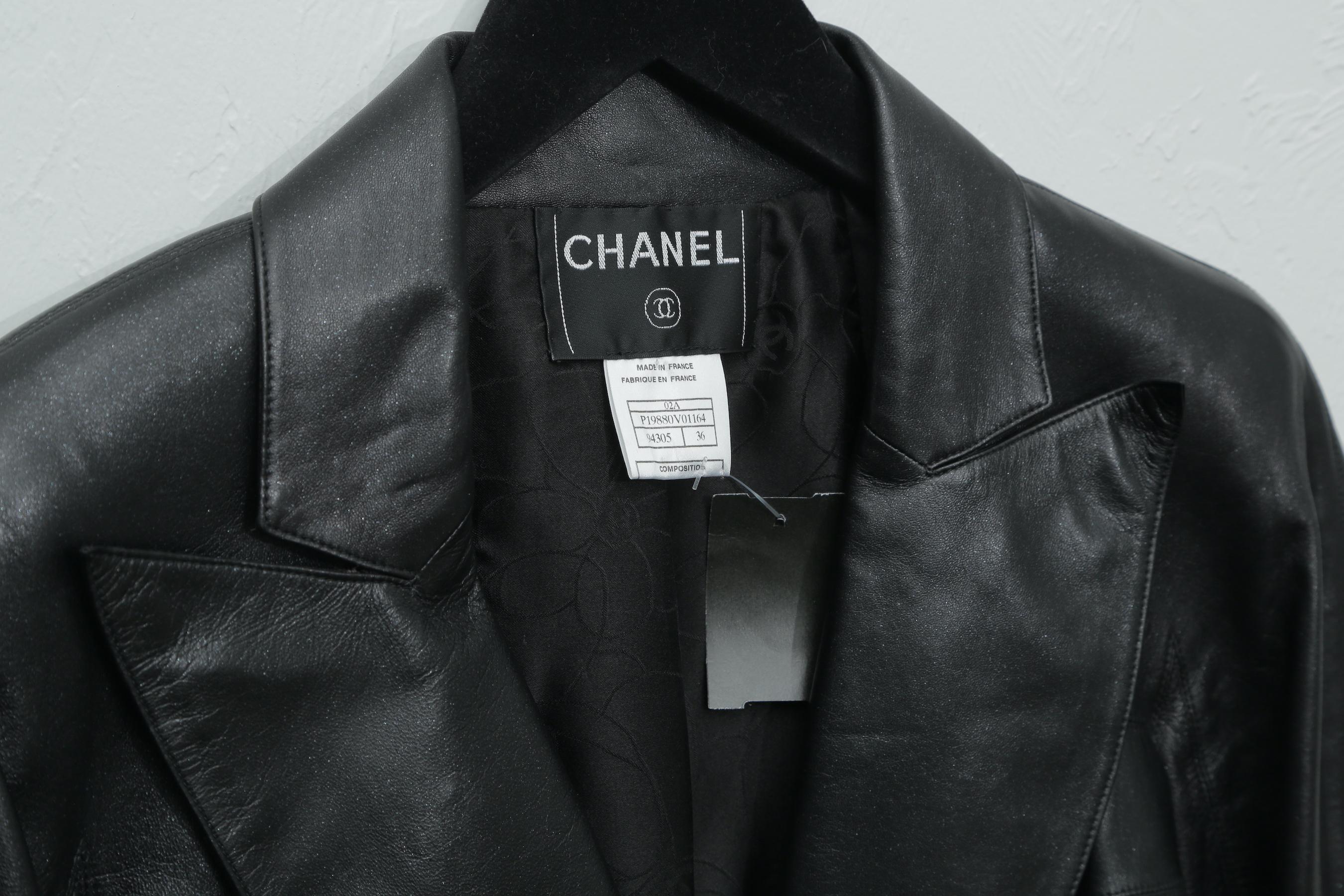 Chanel black metallic leather fitted jacket with three silver logo buttons and vertical pockets.  This is a truly stunning jacket in pristine condition. 4 small