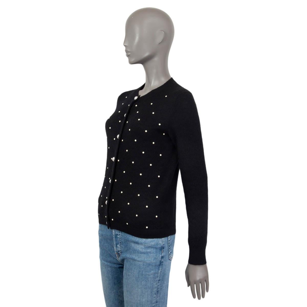 black sweater with pearl buttons