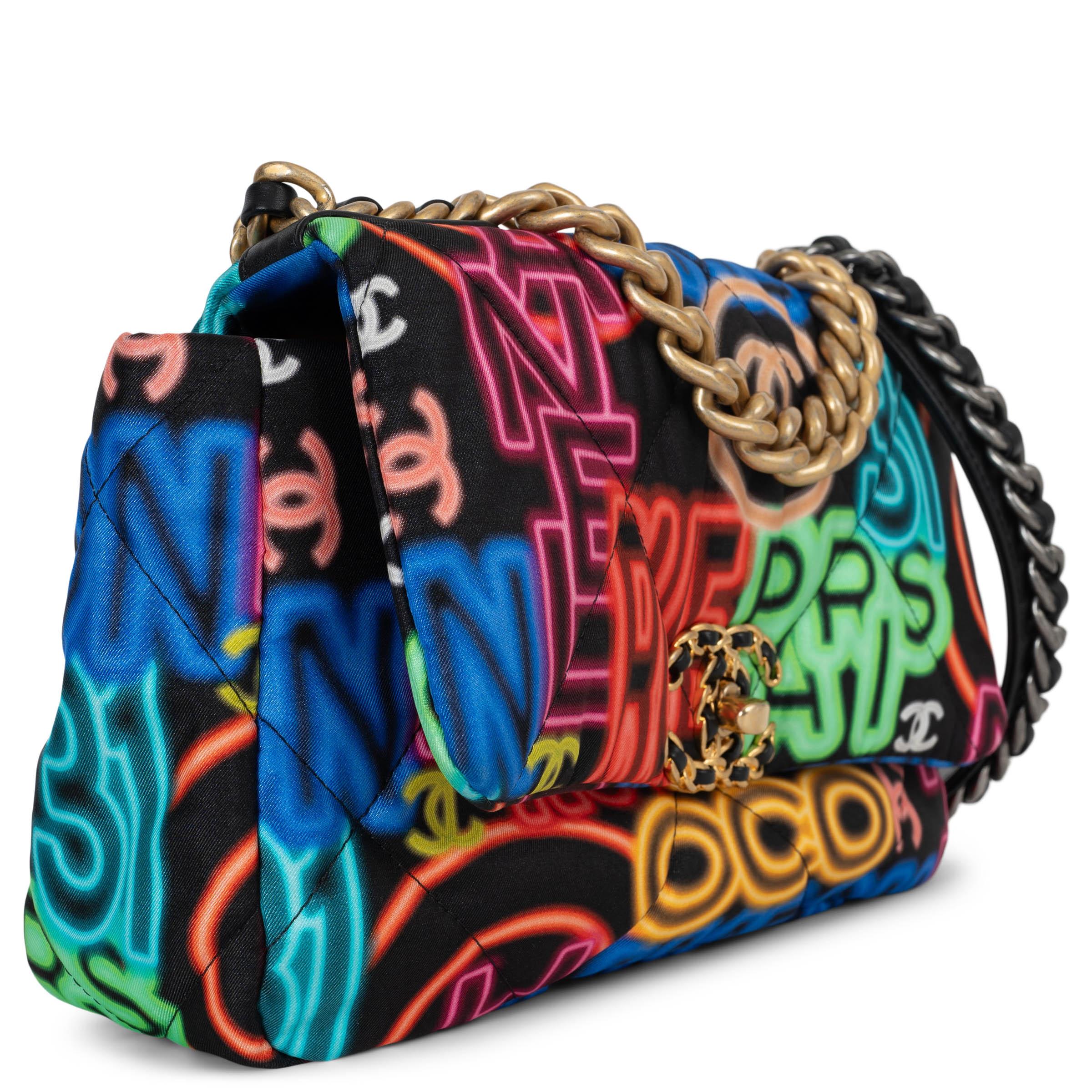 This 100% authentic Chanel 19 Medium shoulder bag in black nylon fabric showcases a vibrant multicolor Chanel icons print, inspired by neon signs. Featuring mixed hardware—including aged gold-tone, ruthenium, and silver-tone metals—it is designed
