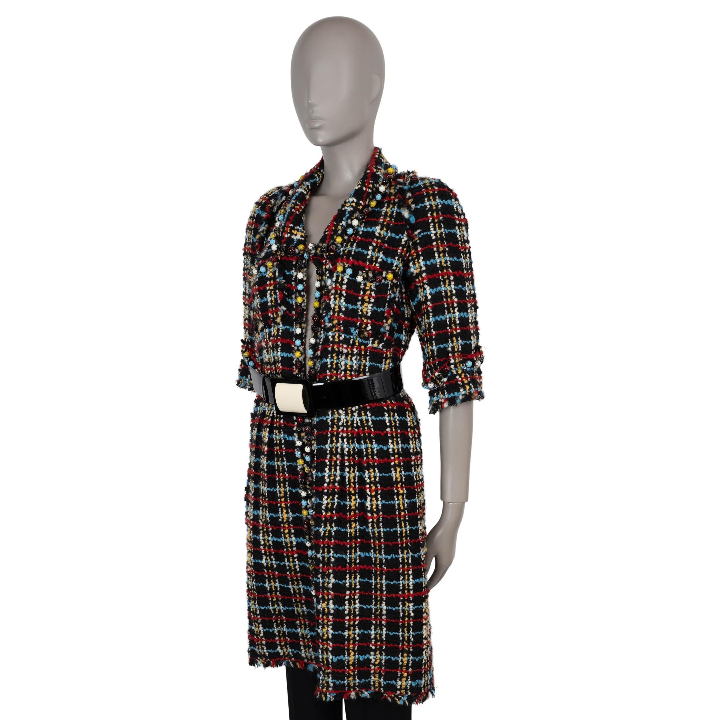 This 100% authentic Chanel runway coat is crafted in black and multicolored tweed (71% wool, 19% silk, 10% acrylic) and embellished throughout with multicolored cabochon beads. Designed in a fitted, knee-length silhouette, it cinches at the waist