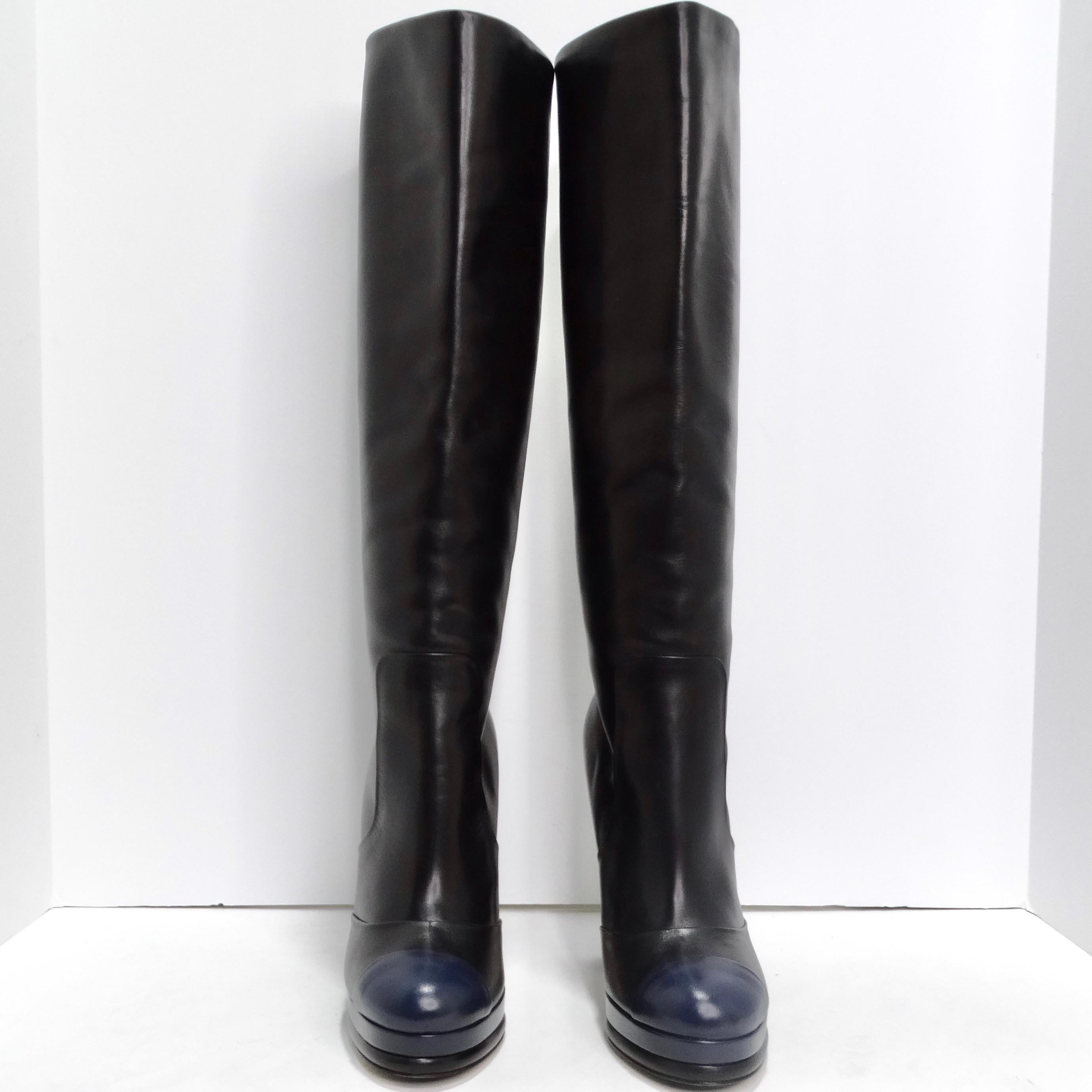 Step into the epitome of luxury and style with these Chanel Black/Navy Blue Leather CC Boots. Crafted with meticulous attention to detail, these knee-high boots are a testament to Chanel's iconic design and unparalleled craftsmanship. The