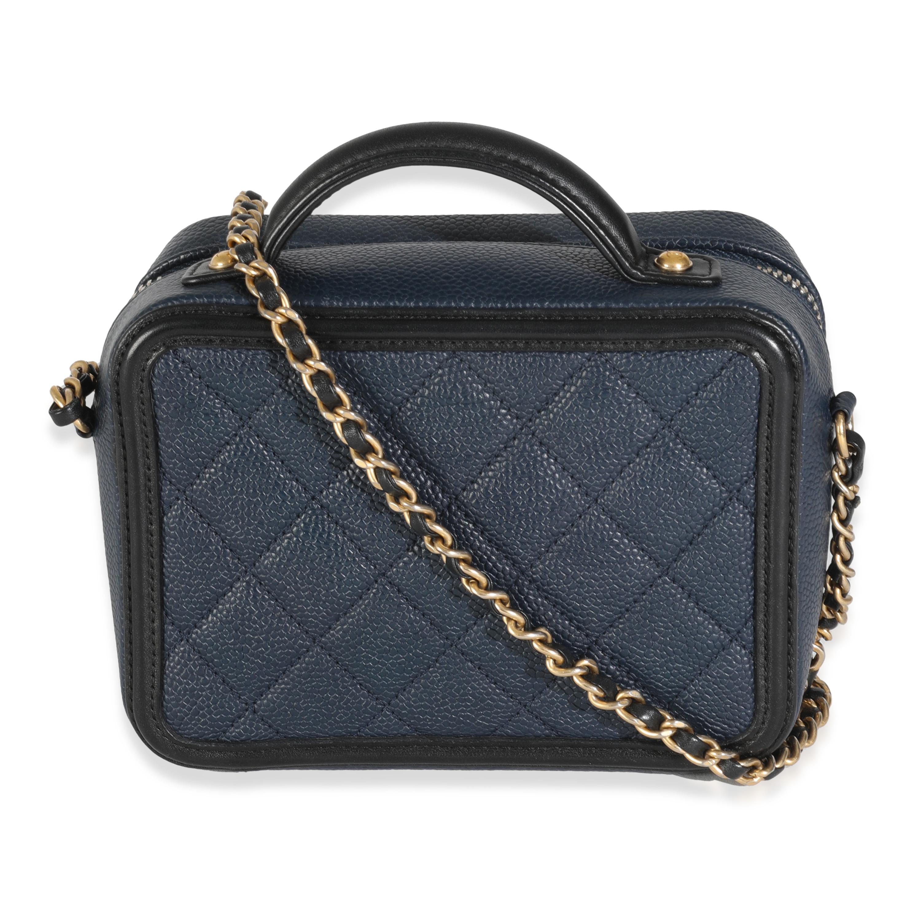 Listing Title: Chanel Black Navy Quilted Caviar Small CC FIligree Vanity Case
SKU: 144483
Condition: Pre-owned 
Handbag Condition: Very Good
Condition Comments: Item is in very good condition with minor signs of wear.  Fraying along zipper track.