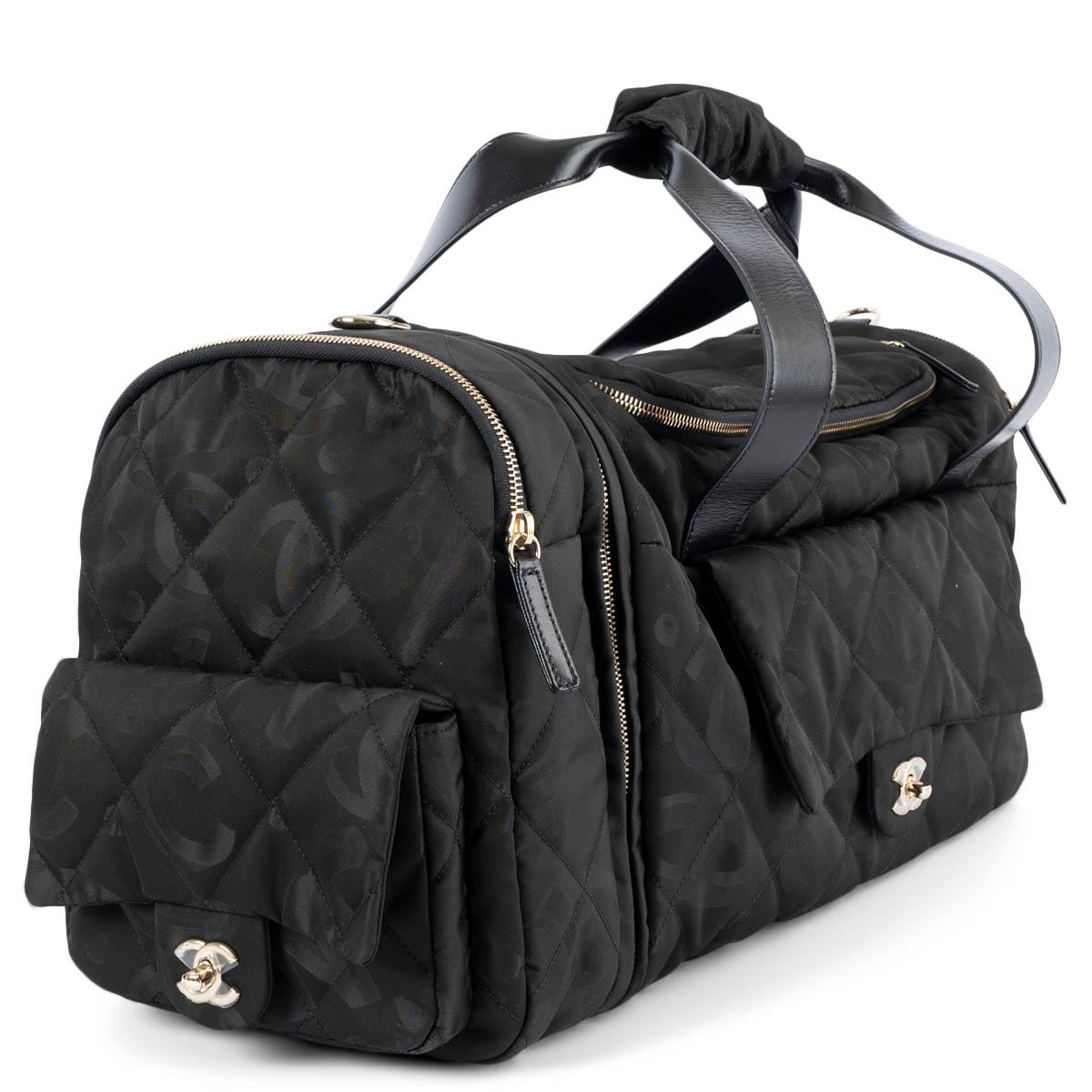 100% authentic Chanel  Two-in-One duffle bag and backpack in black logo nylon with black calfskin trim. Opens with a zipper on top and is lined in tonal fabric with a zipper pocket against the back. The design features a CC turn-lock front pocket, a
