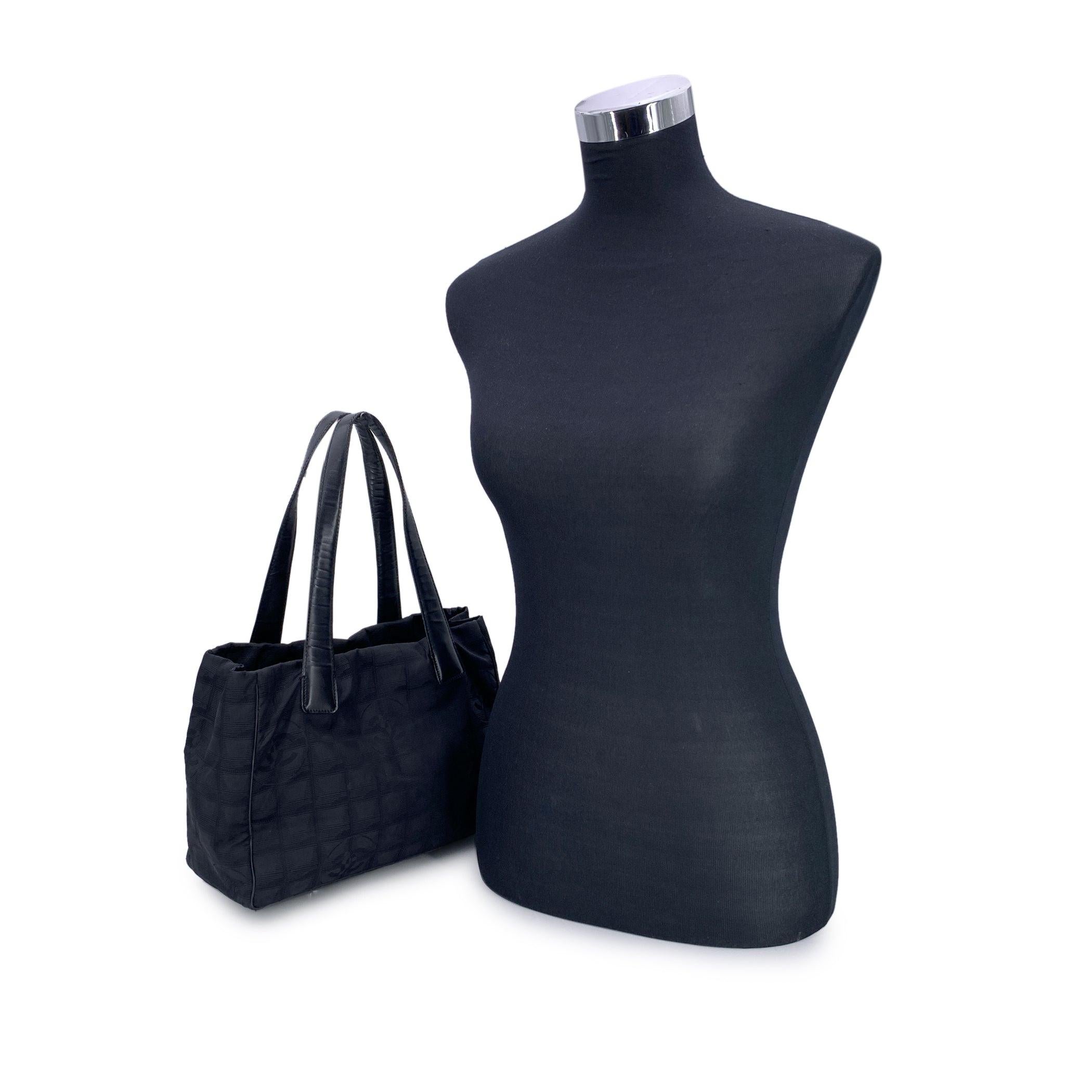 Chanel Travel Line Tote (2003-2004) - Understated Elegance in Motion Timeless, functional, and distinctly Chanel - this black jacquard nylon tote from the house's Travel Line collection is a minimalist masterpiece from the 2003-2004 era, designed