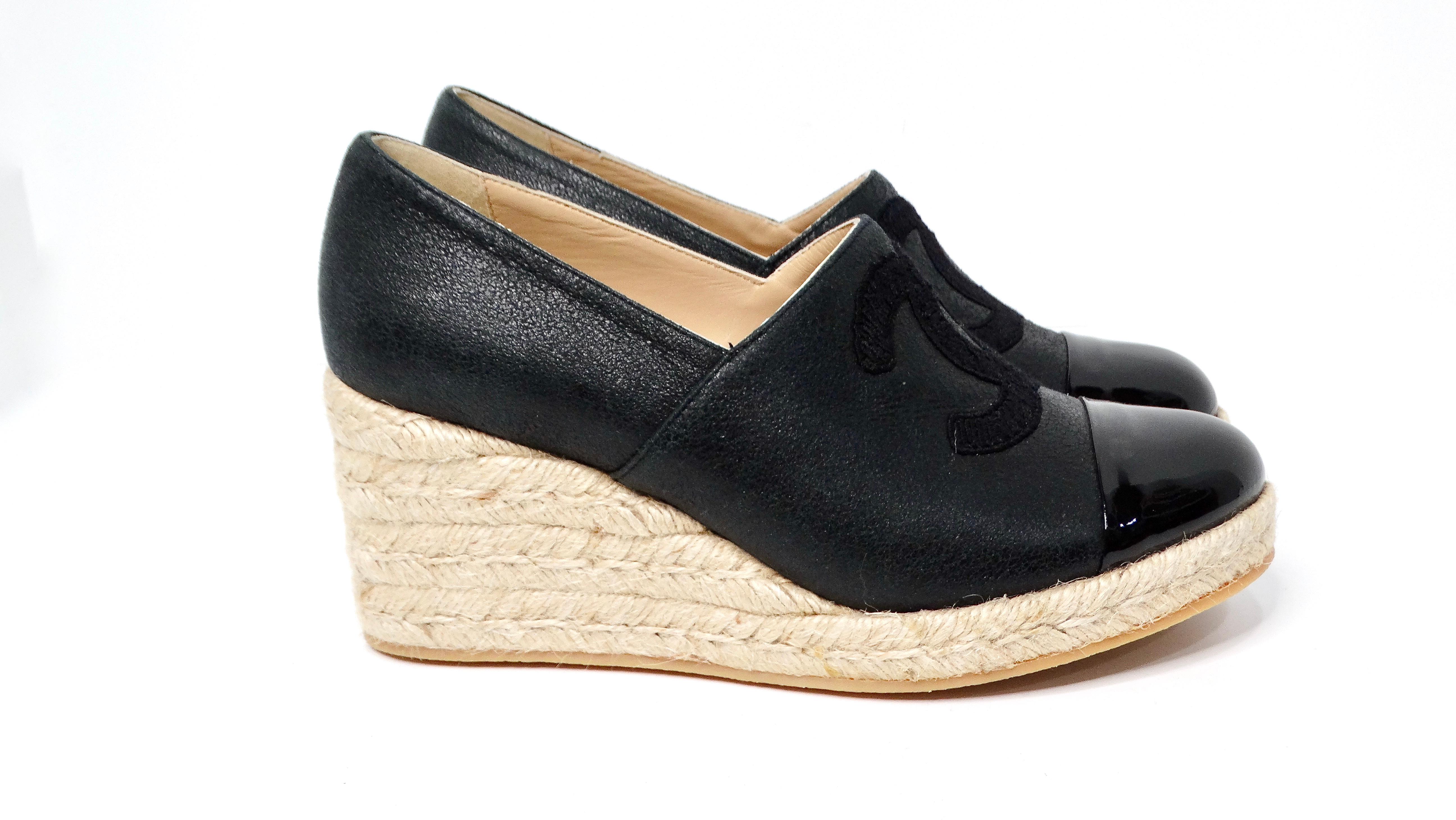 The Chanel Black On Black Leather Interlocking CC Espadrille Wedges seamlessly blend elegance and comfort, creating a versatile addition to any chic wardrobe. Featuring classic espadrille jute soles, these wedges elevate the traditional design with