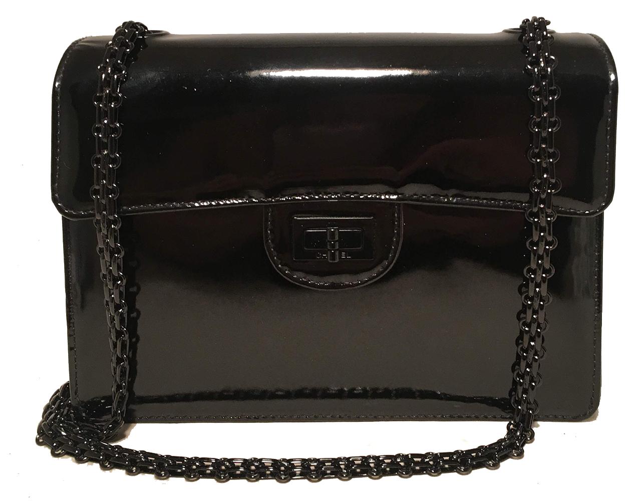 Chanel Black on Black Patent Leather Classic Flap Shoulder Bag in excellent condition. Black patent leather exterior trimmed with black hardware. Mademoiselle twist closure opens to a black leather interior that has one slit and one zipped side