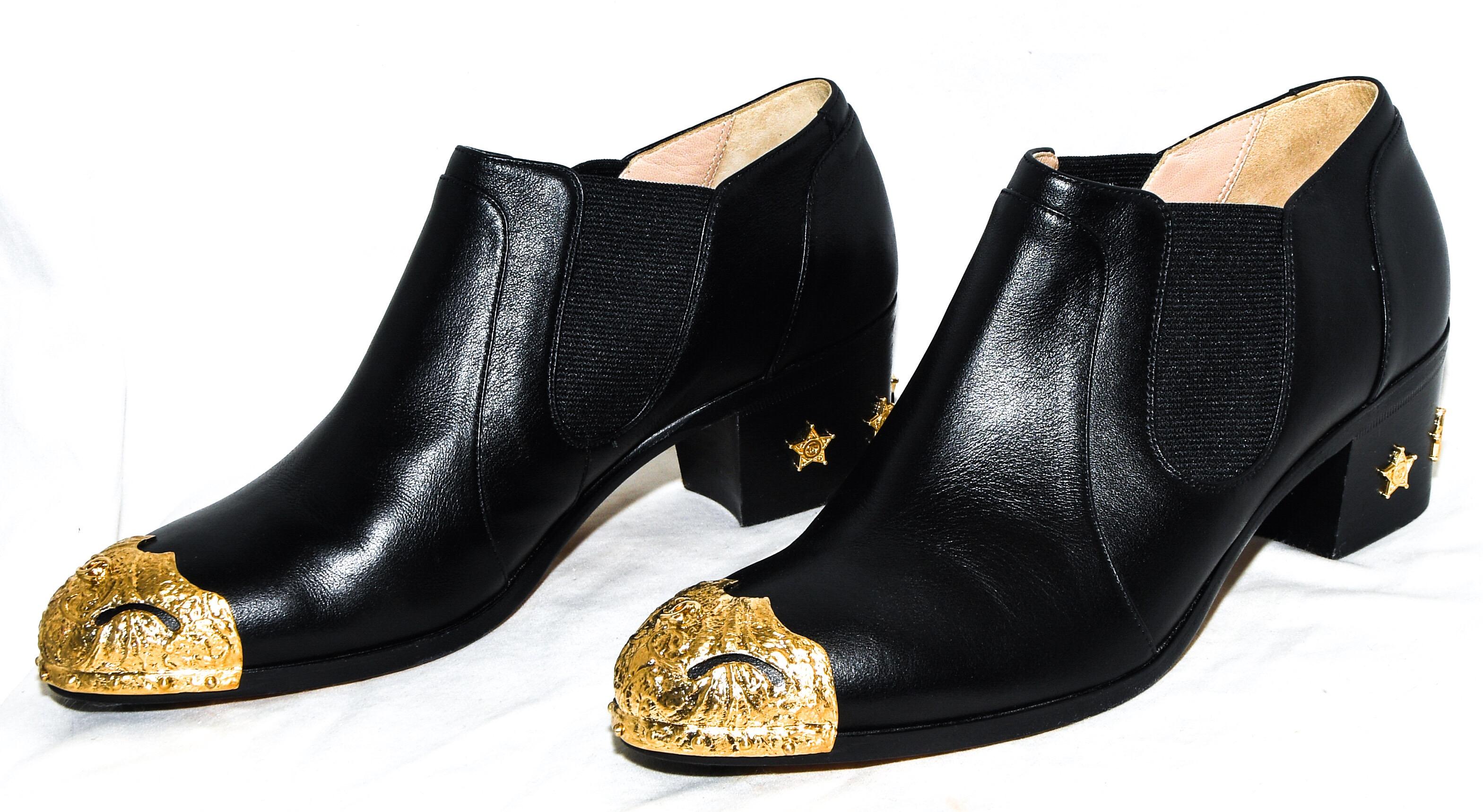 Chanel black leather ankle boots  from the pre- fall Metiers D'arts collection Paris to Dallas bringing a little bit of Paris to the heart of Texas!  These boots incorporate round toe gold metal cap toes in a distinct longhorn design and the iconic