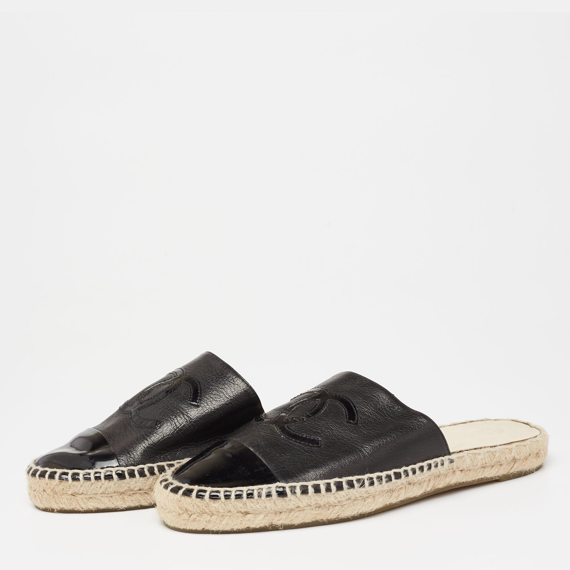 Updated with a brand motif on the front, these Chanel mules signify comfort. The pair comes created from leather and patent leather and is paired with espadrille trims, rubber soles, and a slip-on fitting.

