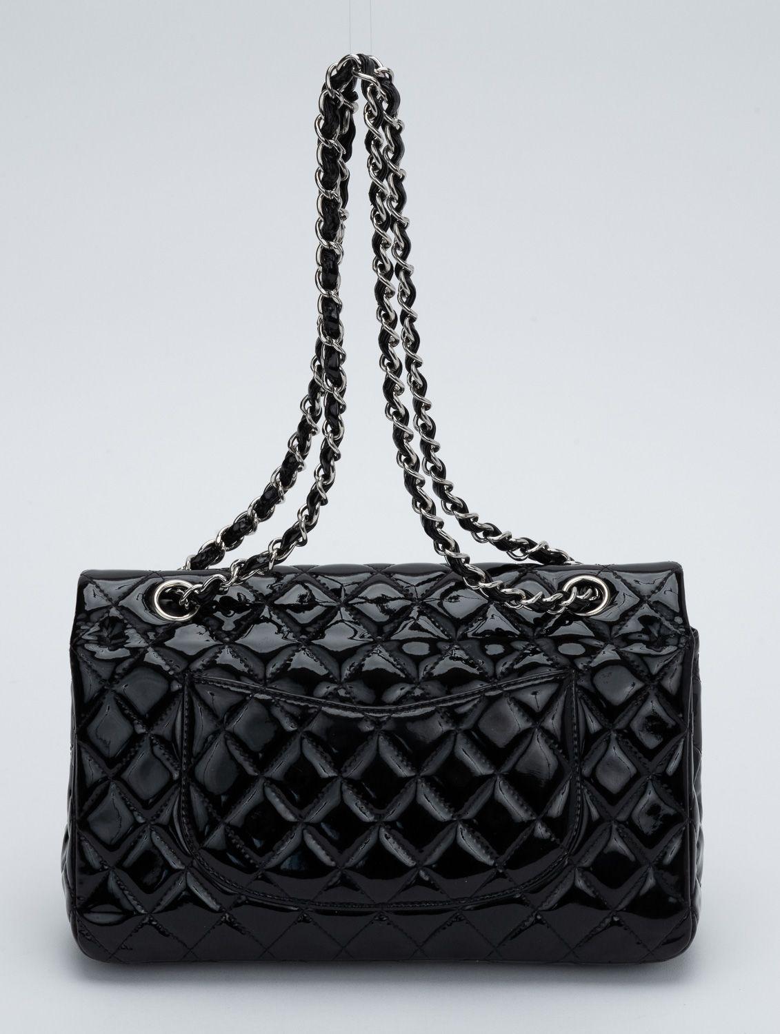 Chanel black classic double flap in patent leather and silver tone hardware. Can be worn two ways: shoulder drop, 17.5