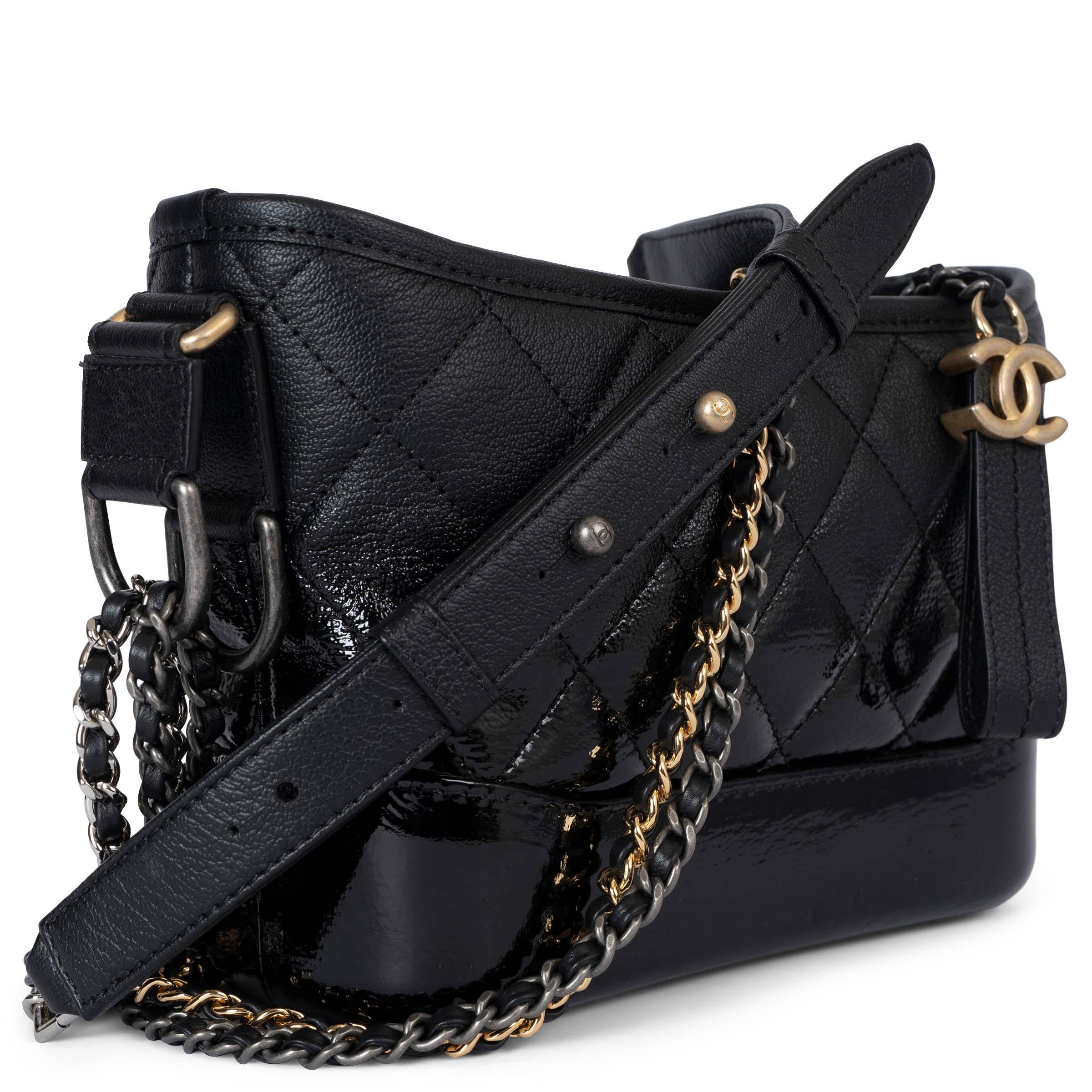 This 100% authentic Chanel Gabrielle Small Hobo Bag is crafted from black quilted goatskin, with a unique fade from matte at the top to glossy at the bottom for a striking contrast. It features a versatile double chain shoulder strap in gold-tone,