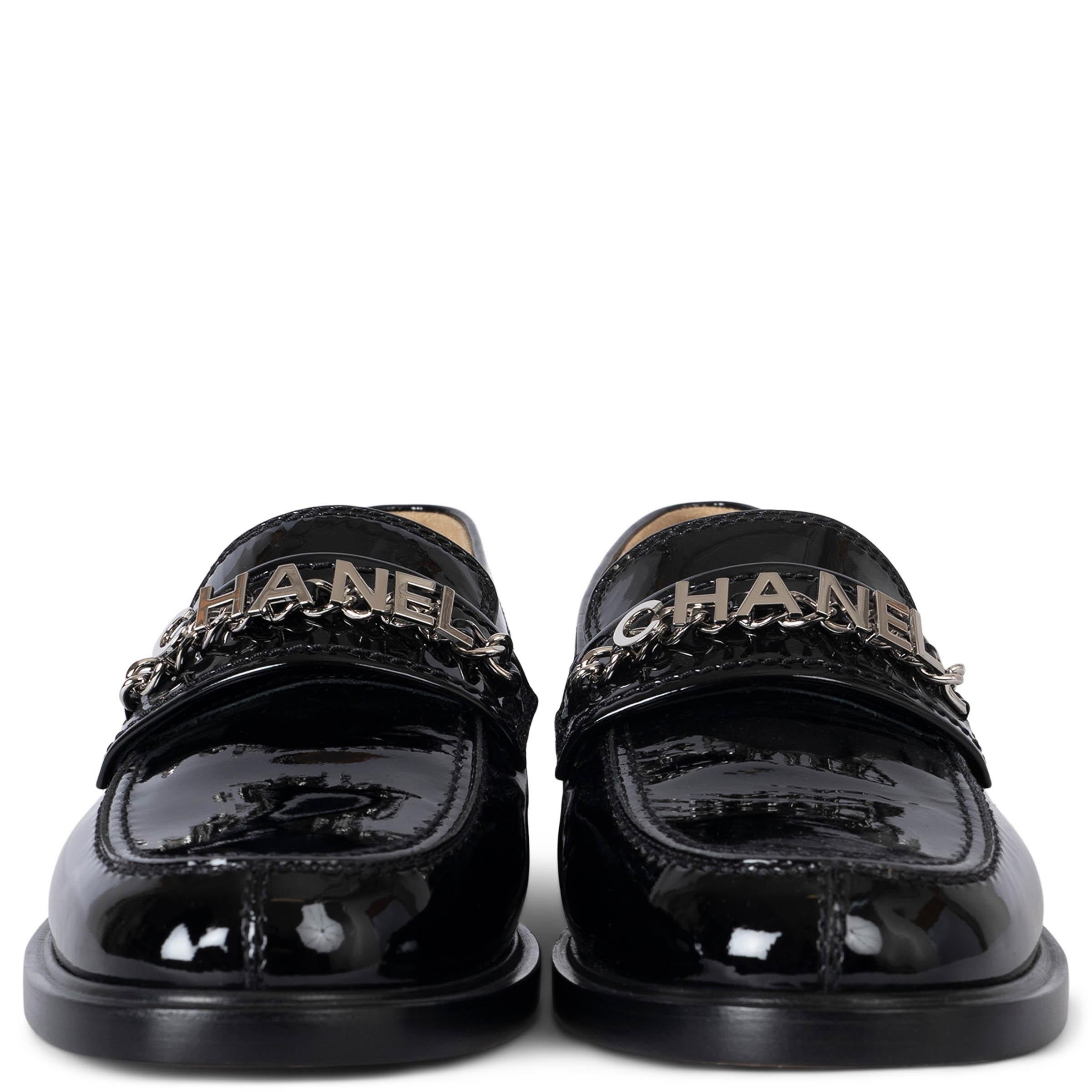 These 100% authentic Chanel loafers are crafted from black patent calfskin and feature silver-tone logo lettering set on the signature Chanel chain for a luxurious touch. A CC metal logo adorns the heel, adding iconic branding to these elegant