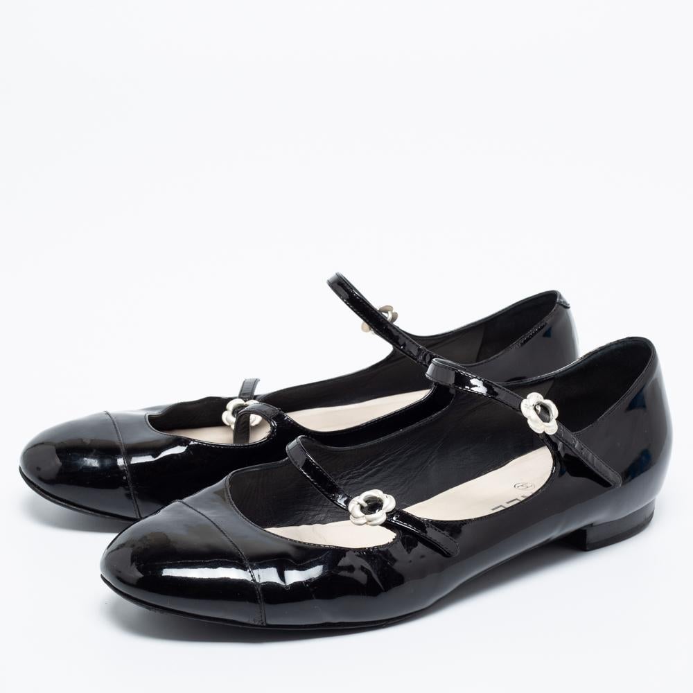 These ballet flats by Chanel are comfortable and chic to be matched with everything from a dress to skinny jeans. Crafted from black patent leather, they have round toes, low heels, and buckled straps.

Includes: Original Dustbag
