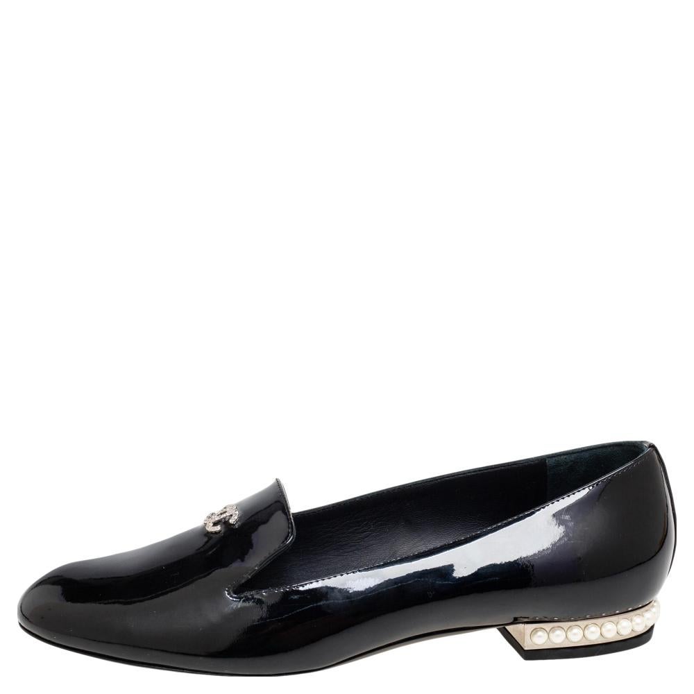 How classy are these loafers from the House of Chanel! They are made from black patent leather on the exterior, with a crystal-embellished CC accent decorating their vamps. They showcase a slip-on feature, silver-tone hardware, and faux-pearl