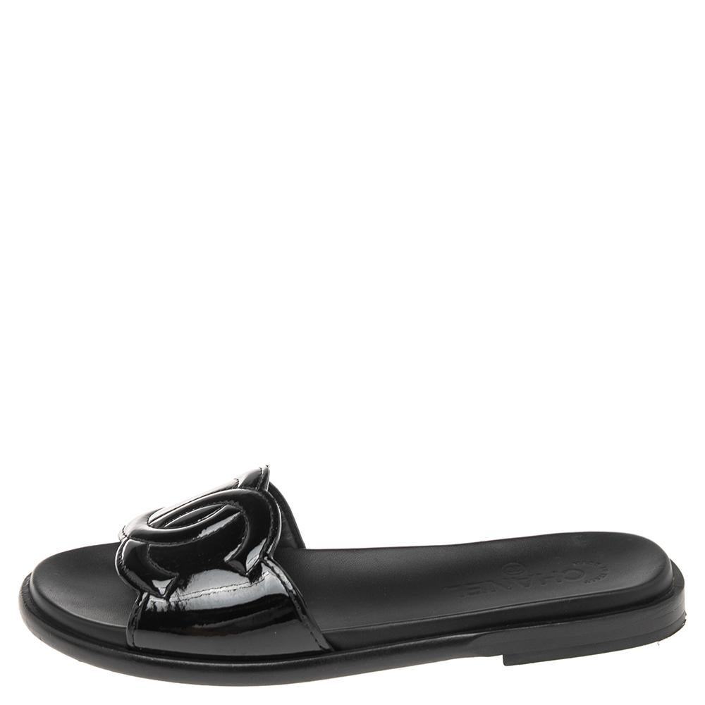 This pair of Chanel sandals will keep your look chic and summery. Made from patent leather, their black vamps are designed with the signature interlocking CC logos. They are designed with comfortable insoles and durable soles.

Includes: Original