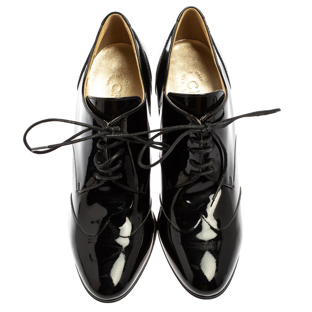These premium derby booties by Chanel are a showstopper pair. Made from black patent leather, these shoes are classically crafted with laced up fronts. Gold-tone CC logo makes an appearance near the counters. Accented with 9.5cm heels, they have