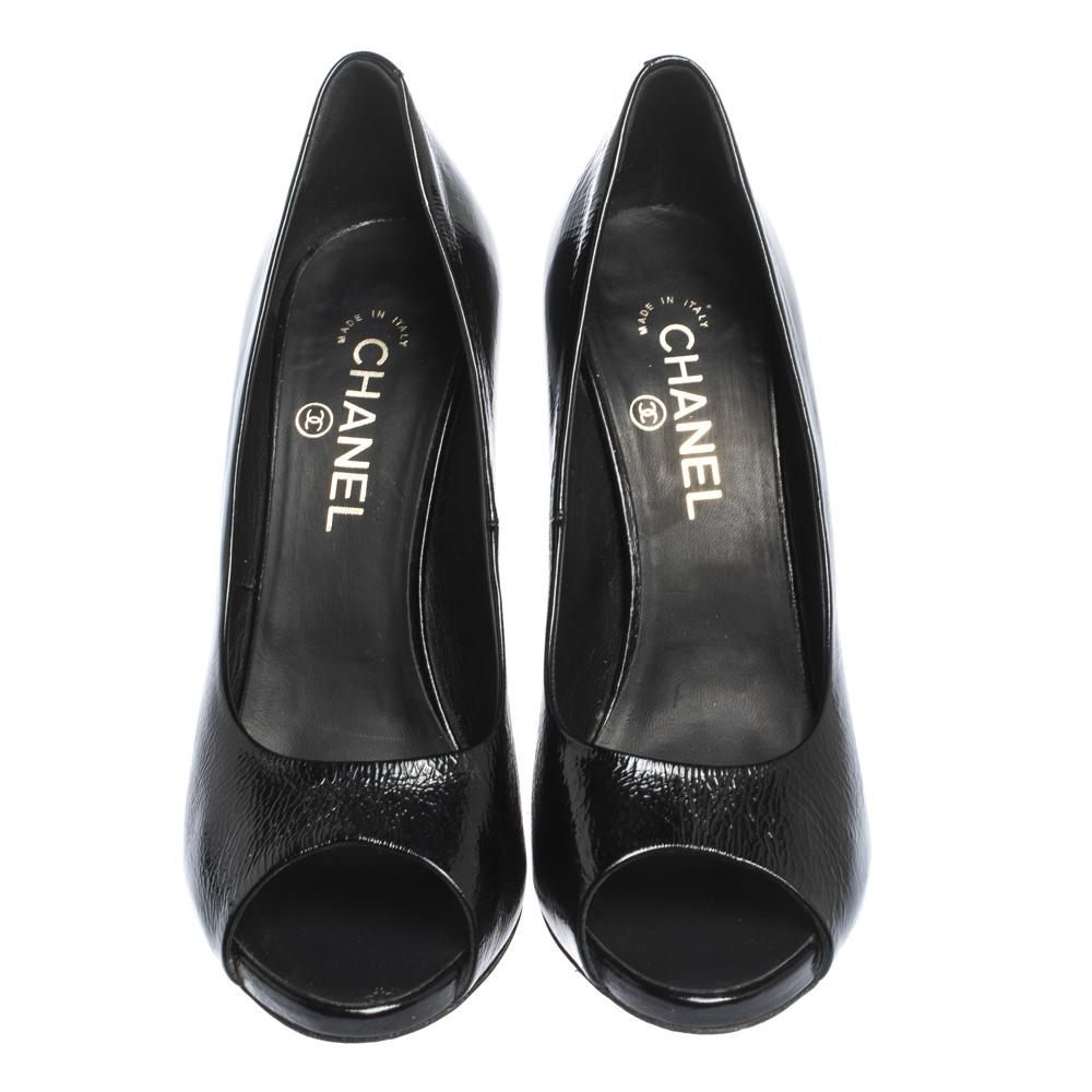 The perfect blend of luxury and elegance, these pumps from Chanel come crafted from black patent leather. Designed with peep toes and durable soles, the pumps flaunt the perfect finishing touch of faux pearls on the heels.

