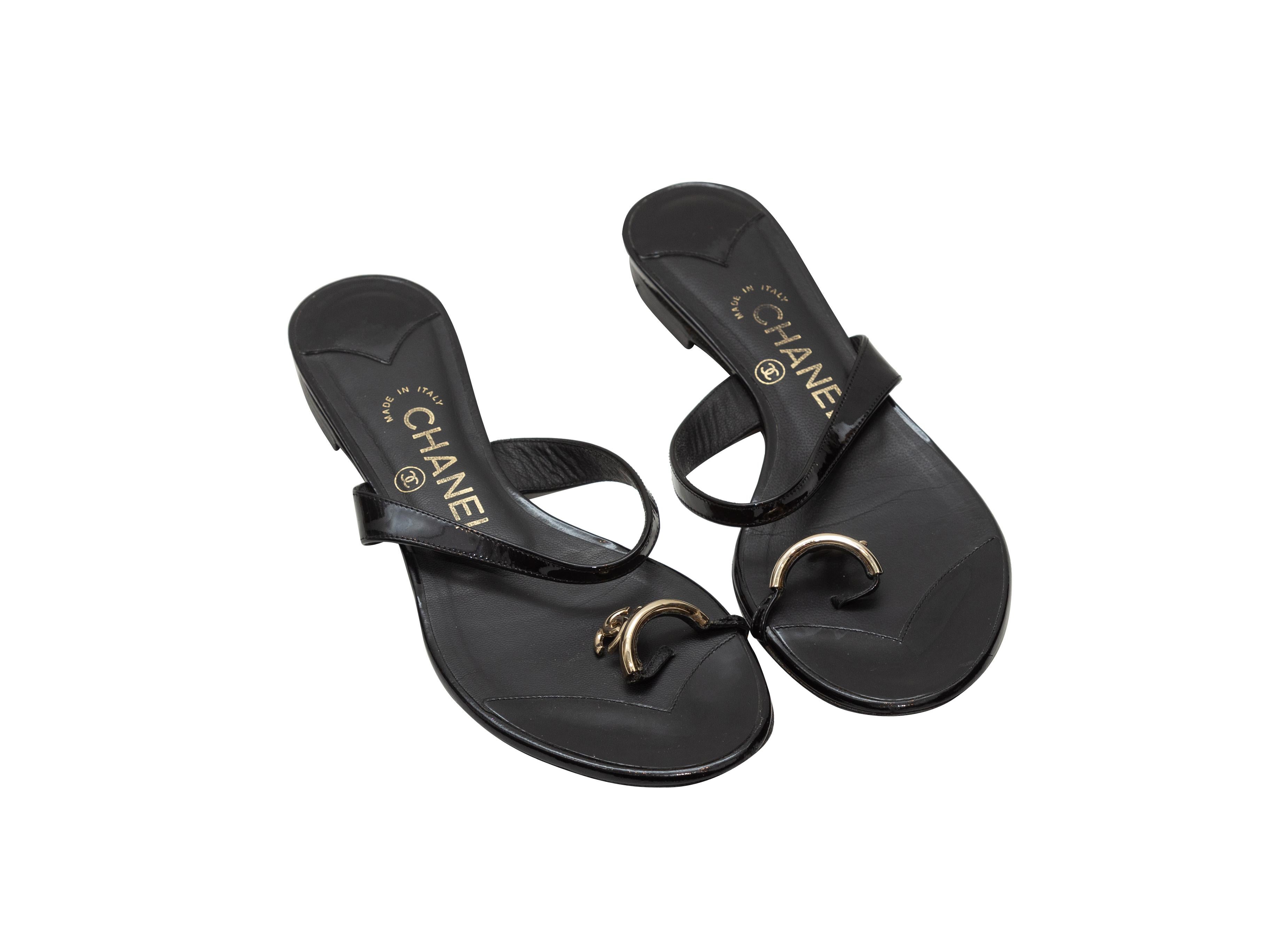 Product details: Black patent leather sandals by Chanel. Silver-tone CC adornments at toes. Designer size 36. 0.75