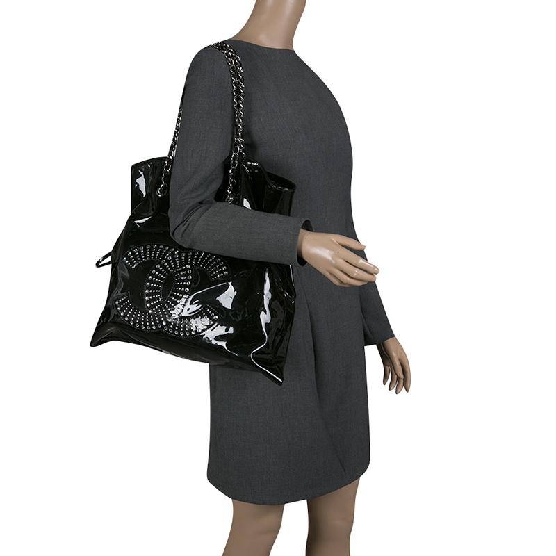 Jazz up your look with this brilliantly designed patent leather Chanel bag. This one is the most convenient and handy accessory you will come across. It features a notable CC stitch on the front detailed with sparkling crystals and drawstring