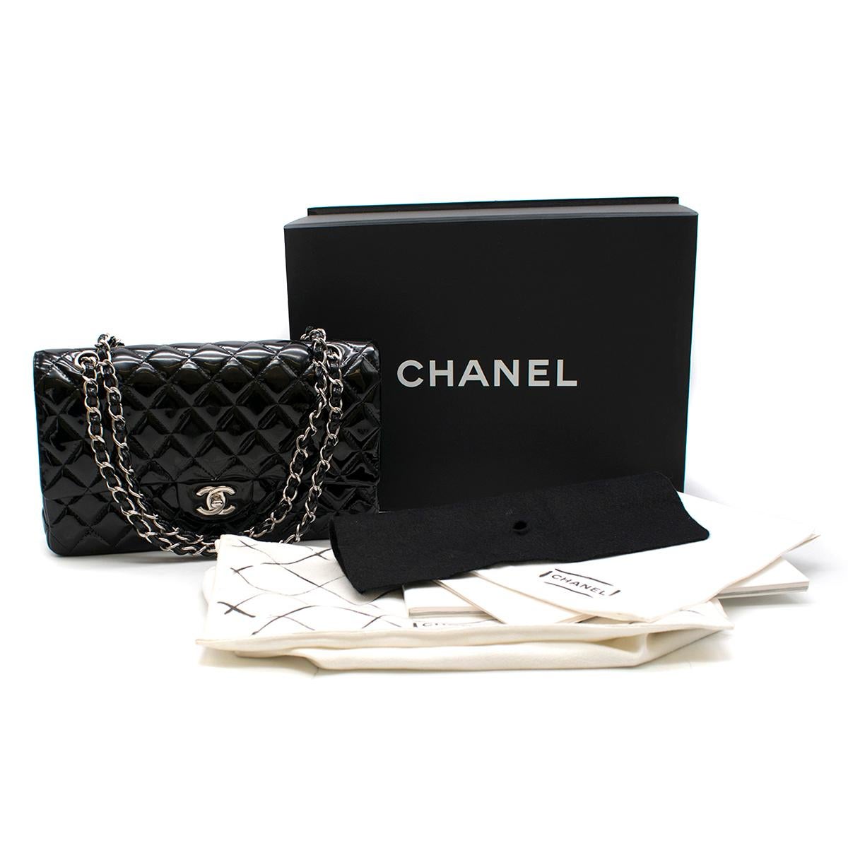 Chanel Black Patent Leather Double Flap Classic Handbag

- Black patent leather quilted classic handbag
- Silver-tone metal interlaced with leather chain
- Front signature CC clasp
- Double flap with zip fastening pocket
- Black leather lining with