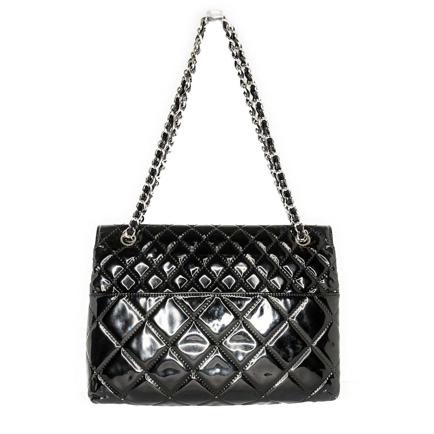 Black quilted patent leather Chanel In The Business shoulder bag with silver-tone hardware, dual convertible chain-link and patent leather shoulder straps, single exterior slit pocket at back, tonal canvas lining, dual pockets at interior wall; one