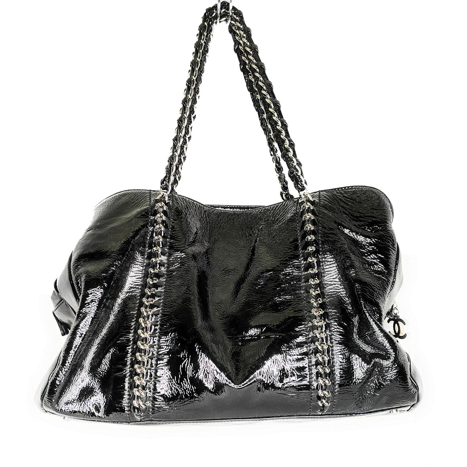 This glamorous Chanel Black Patent Leather Luxe Ligne Large Tote Bag is truly desirable. It features a sleek design with silvertone braided leather/chain straps and embedded chain detailing. It also has two large exterior flat pockets for easy