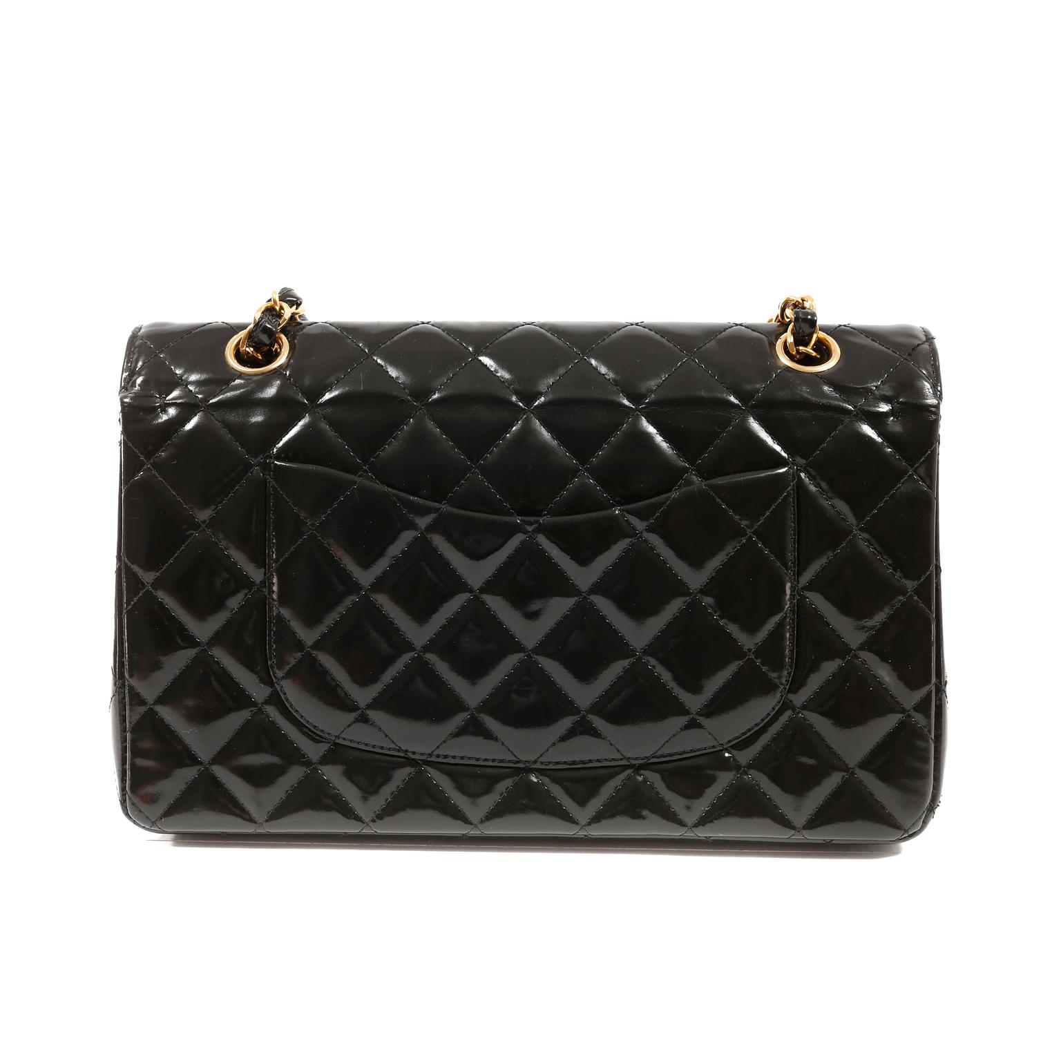 This authentic Chanel Black Patent Leather Medium Classic Flap is in pristine condition.  A truly timeless classic, the medium flap bag easily transitions from day to evening and is certain to hold its value.
Durable and weather friendly black