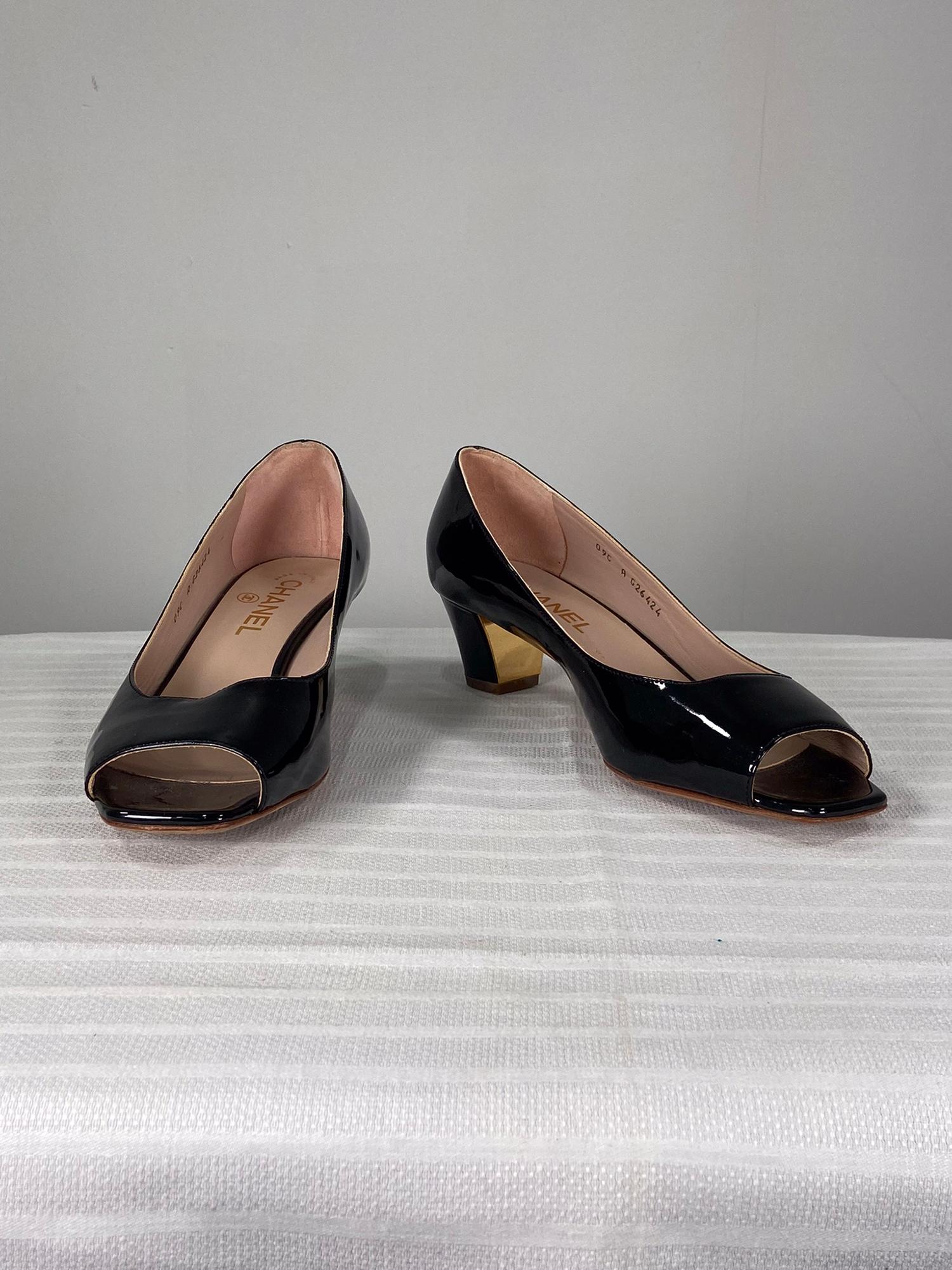 Chanel black patent leather open toe, gold logo heel pumps 39. Beautiful patent leather pumps with an open toe and a low chunky heel which has a gold vertical stripe and a raised CC logo. Marked size 39. In very good pre-owned condition, soles have