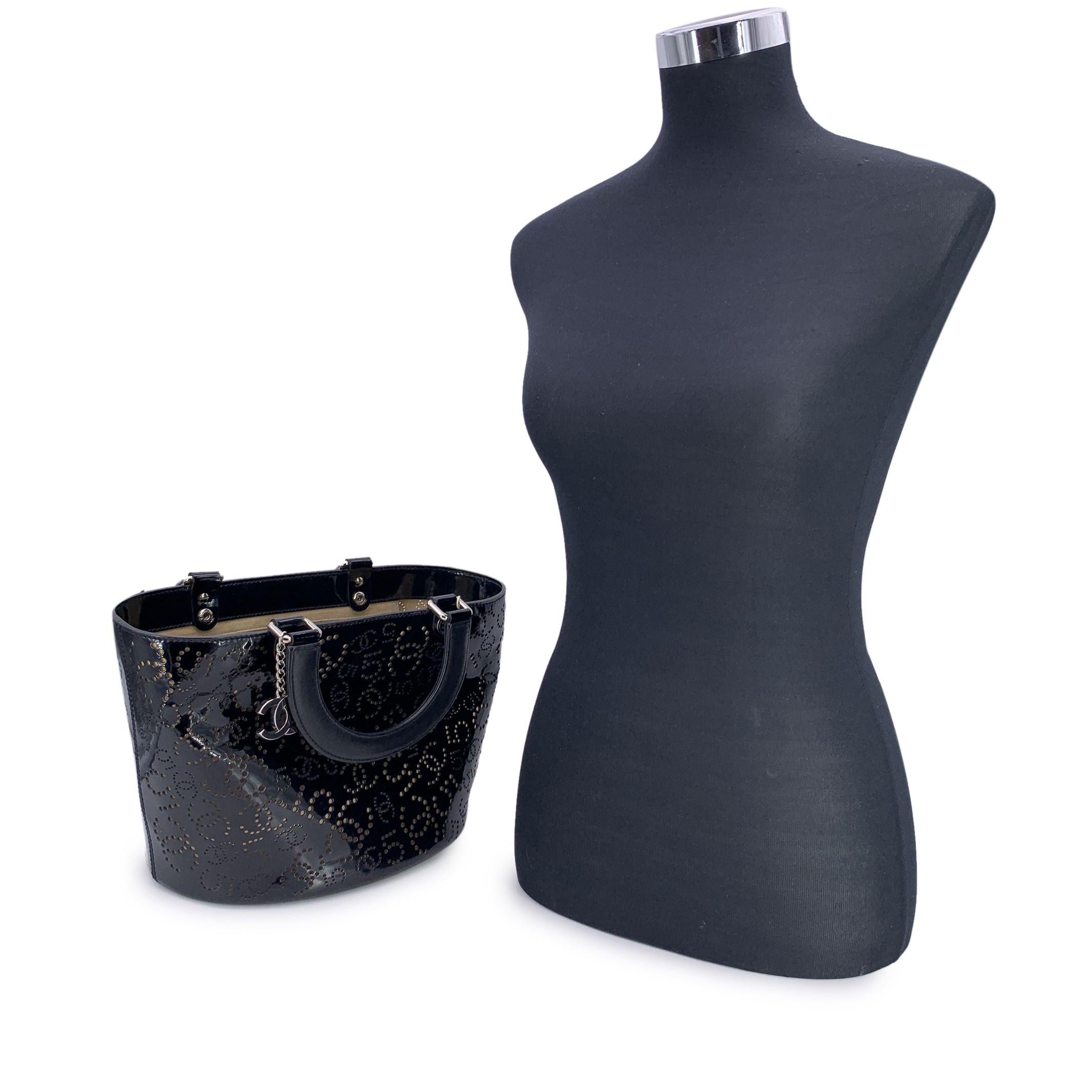 This beautiful Bag will come with a Certificate of Authenticity provided by Entrupy. The certificate will be provided at no further cost Step into the world of iconic design with the Chanel Black Patent Leather Perforated No. 5 Tote, a standout