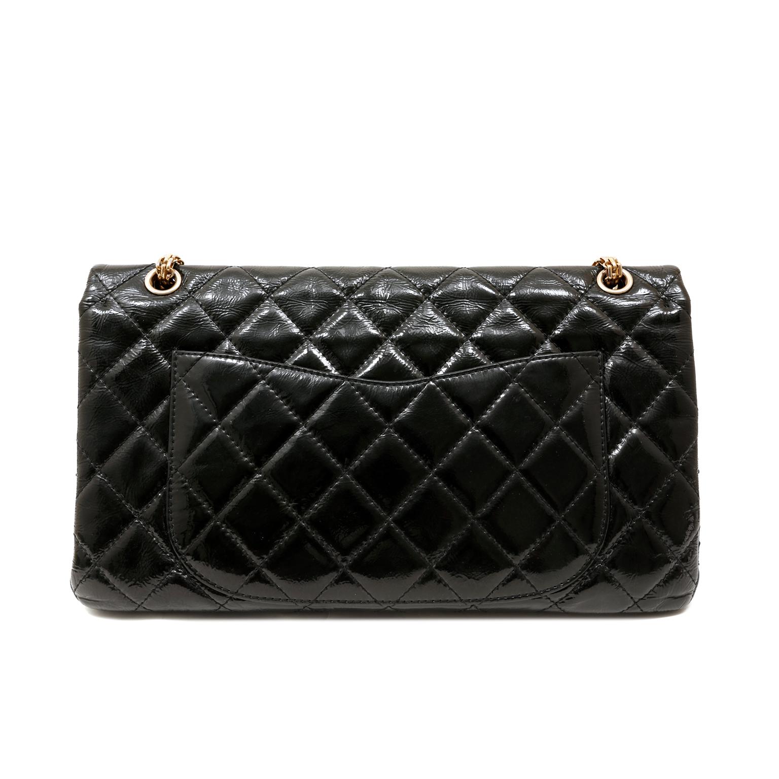 This authentic Chanel Black Patent Leather Reissue Maxi Flap Bag is in excellent condition.  The Maxi, or 228 size, is highly coveted and very collectible.
Black weather friendly patent leather is quilted in signature Chanel diamond pattern.  Gold