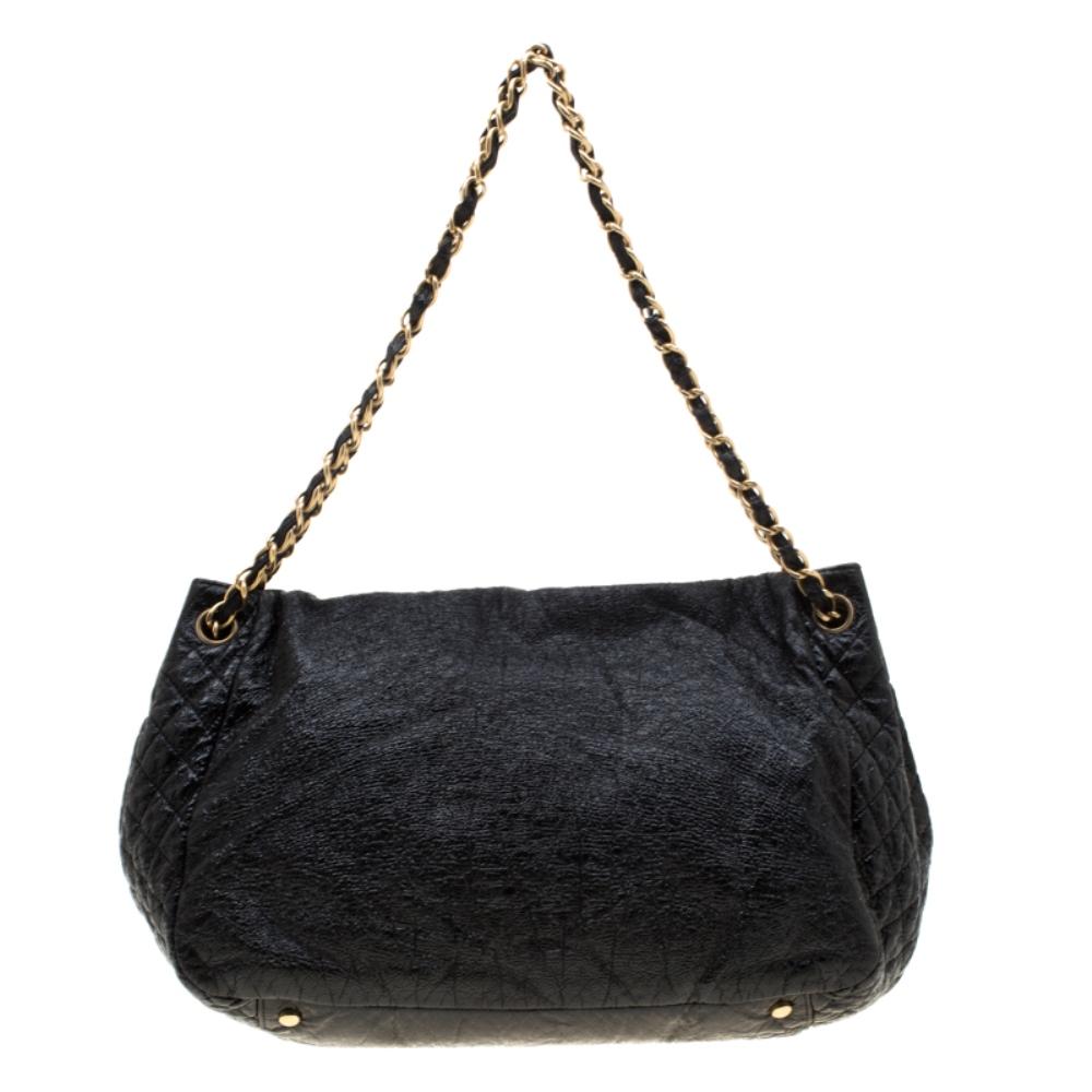 One cannot go wrong with a piece like this from Chanel! An ideal fashion adornment, this Rock and Chain bag has a well-sized satin interior while the leather exterior is covered in black and flaunts the signature quilted pattern on the sides.