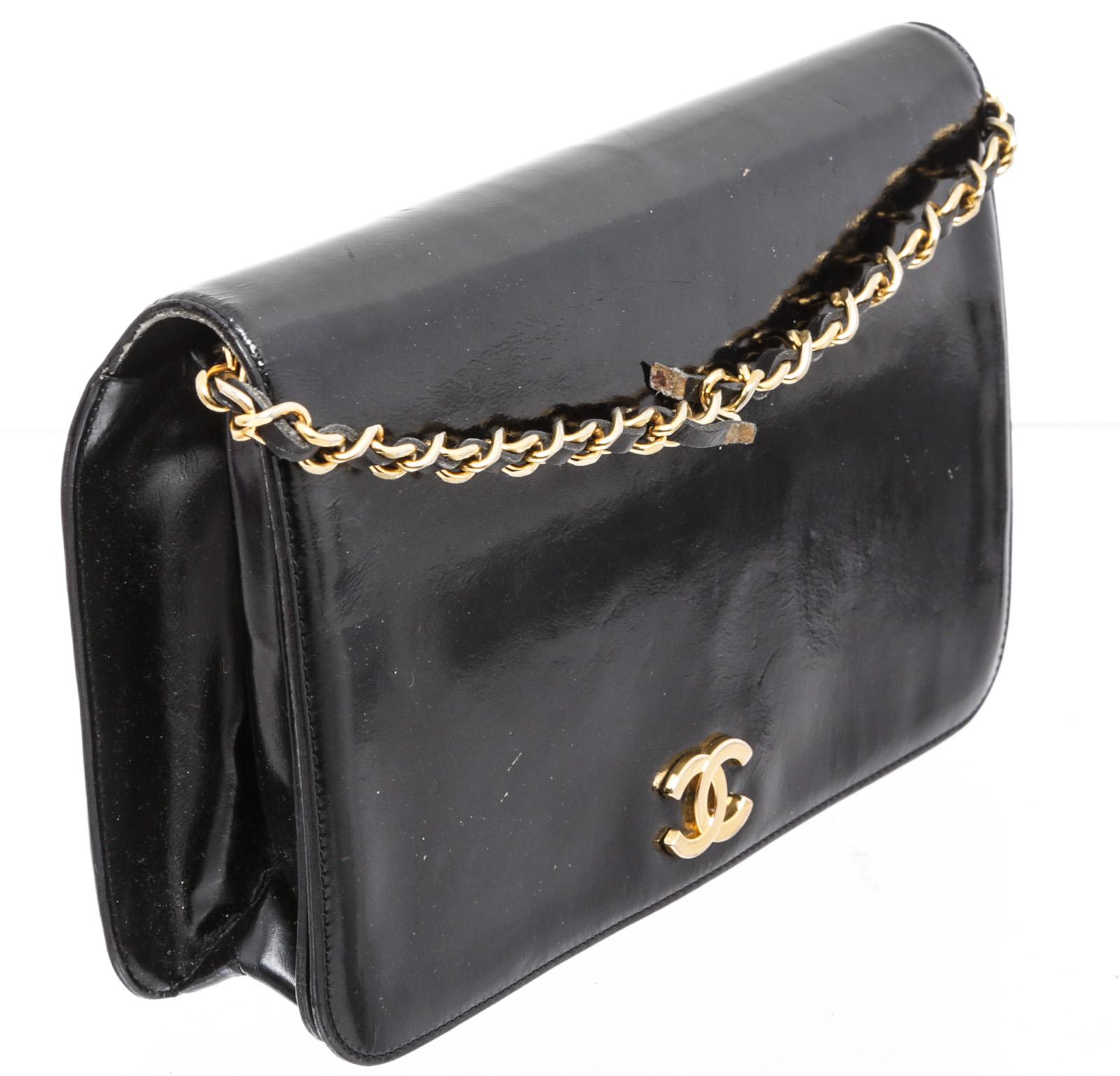Chanel black patent leather small chain shoulder bag with gold-tone hardware, braided chain and leather shoulder strap, black caviar leather interior, one interior zip pocket and overall snap closure featuring CC hardware logo.

24282MSC