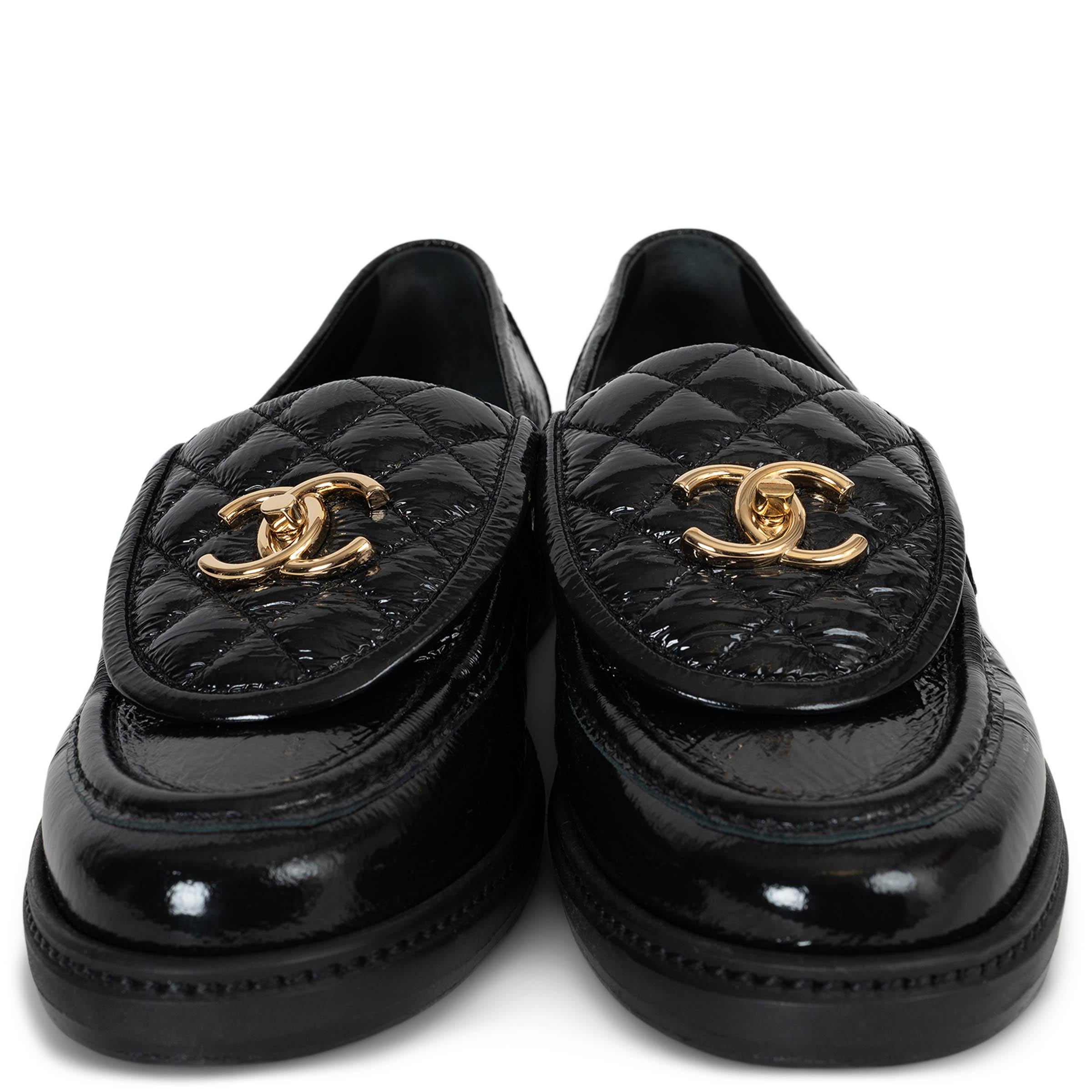 This 100% authentic Chanel turnlock loafers in black patent leather embody timeless sophistication with a modern twist. Featuring a signature quilted flap and adorned with a gold-tone metal CC turnlock, they offer a refined yet statement-making