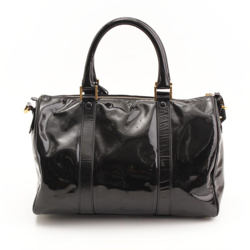 A classic Bowler bag crafted in the bold and statement black patent leather, this Chanel bag is everything that is highly functional and also extremely stylish. With a gold-tone top zipper closure and a classic bowler shape, this bag provides ample