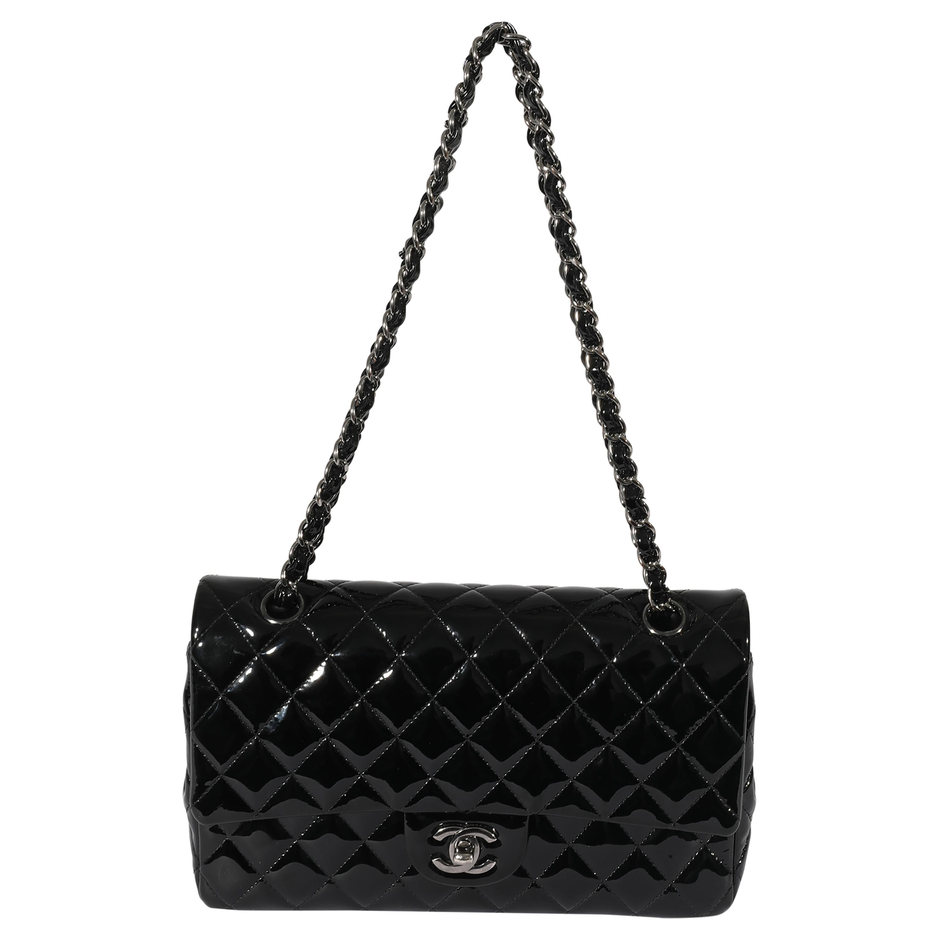 Listing Title: Chanel Black Patent Medium Classic Double Flap
SKU: 127978
MSRP: 8800.00
Condition: Pre-owned 
Handbag Condition: Very Good
Condition Comments: Very Good Condition. Smudging to exterior. Scratching and light tarnishing to hardware.